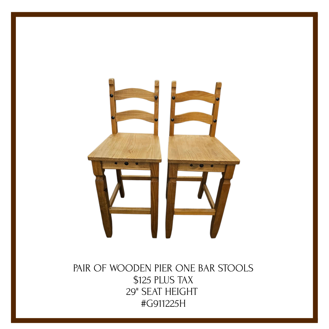 A pair of wooden bar stools with ladder-back design, shown against a white background, with product details and price listed below.