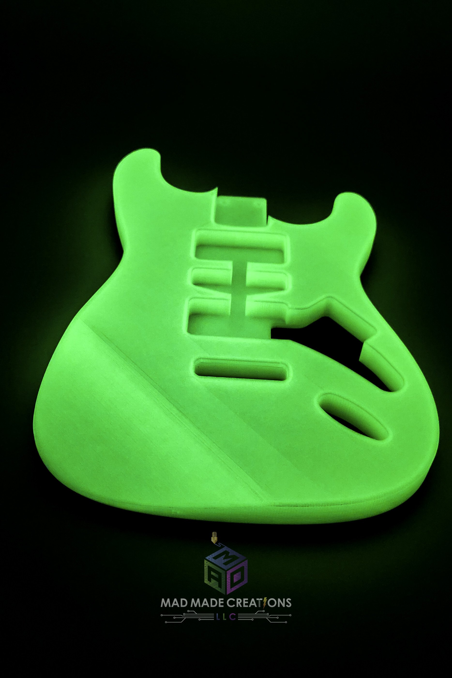 Front view of a glowing green 3D printed HSH Strat-style guitar body with Floyd Rose routing, one-piece custom design by MAD Made Creations
