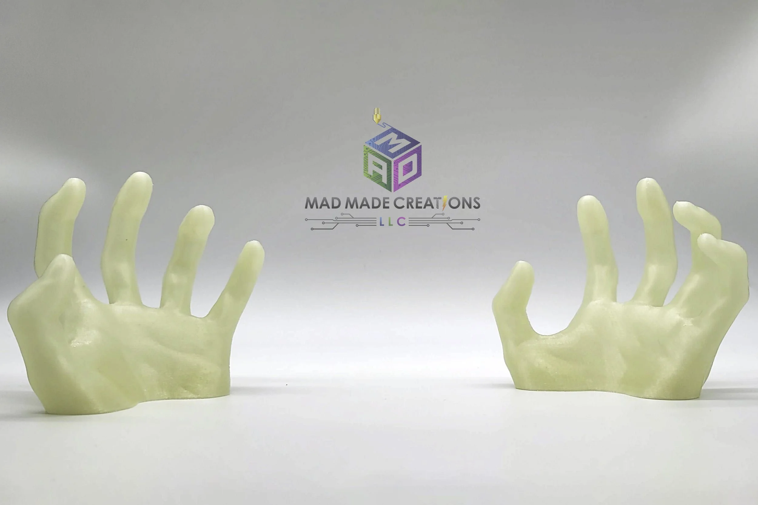 3D printed glow-in-the-dark ghost hands Halloween decorations by MAD Made Creations, shown unlit under bright lighting for product detail