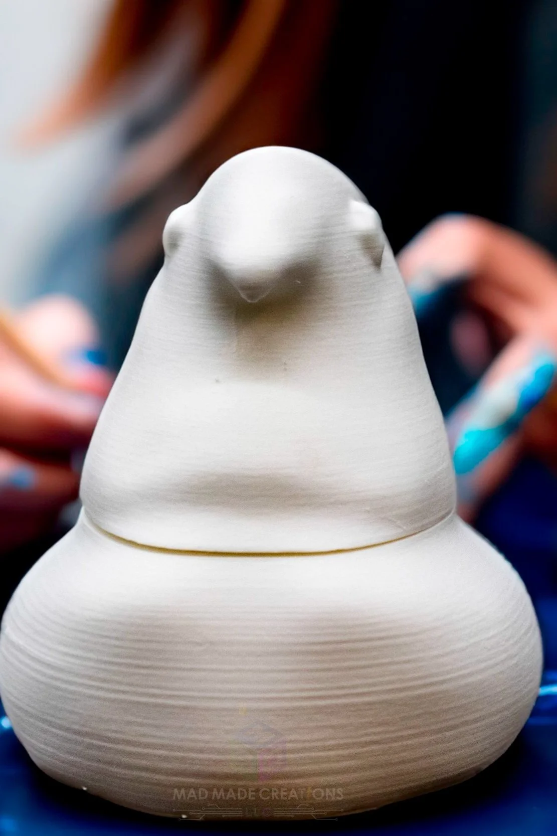 Front view of an unpainted 3D printed Easter chick candy dish being hand-painted during a family DIY craft activity, part of the decorate-it-yourself Easter collection by MAD Made Creations