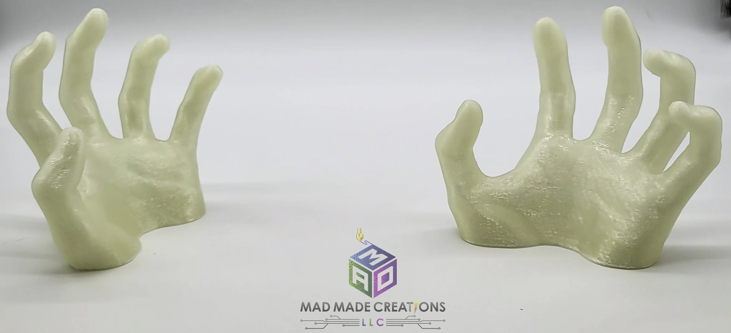 Pair of large 3D printed glow-in-the-dark human ghost hands for Halloween, shown under bright lighting by MAD Made Creations