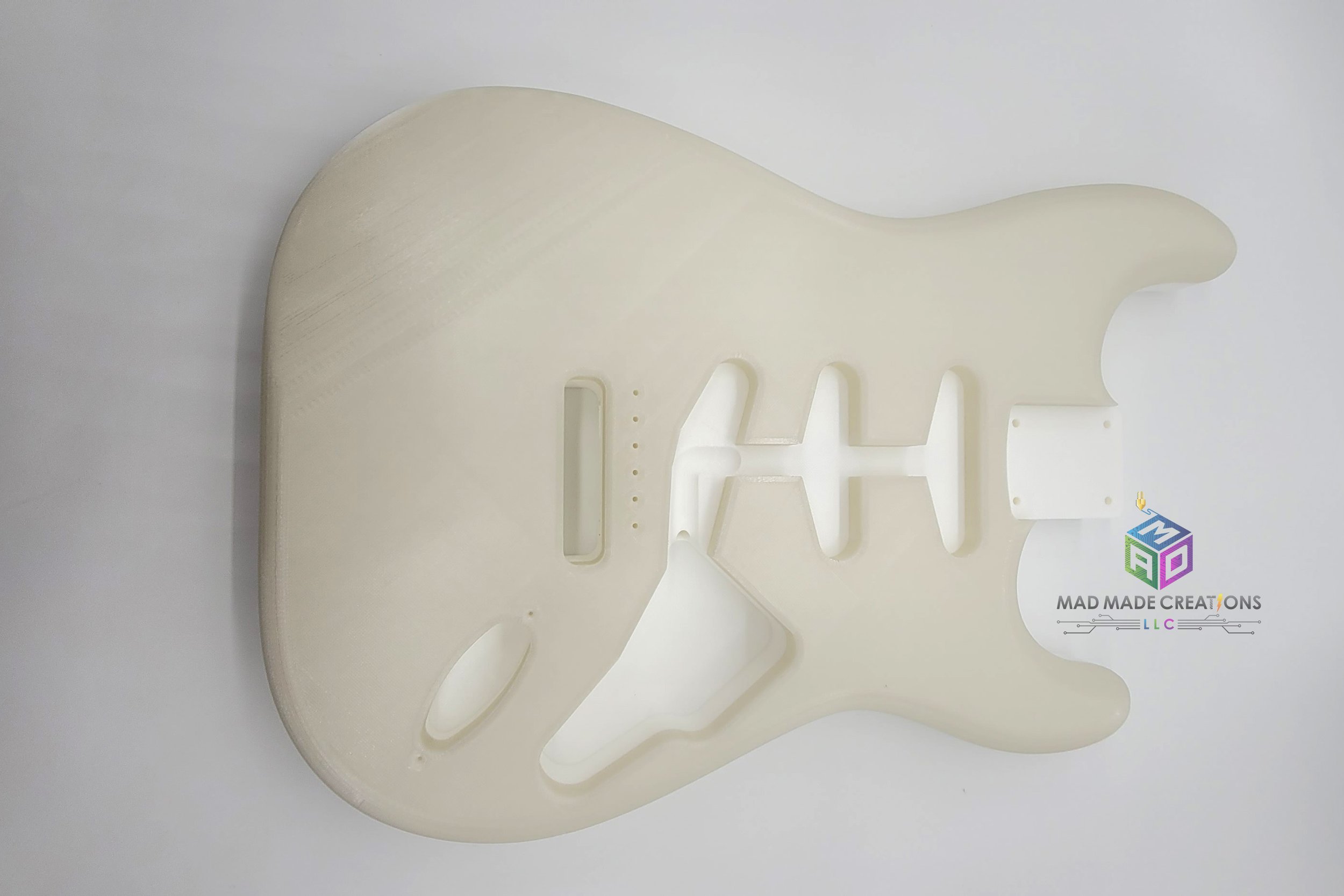 Front view of Strat SSS style guitar body – custom one-piece 3D printed guitar body in blue glow-in-the-dark filament by MAD Made Creations, shown unlit under standard lighting