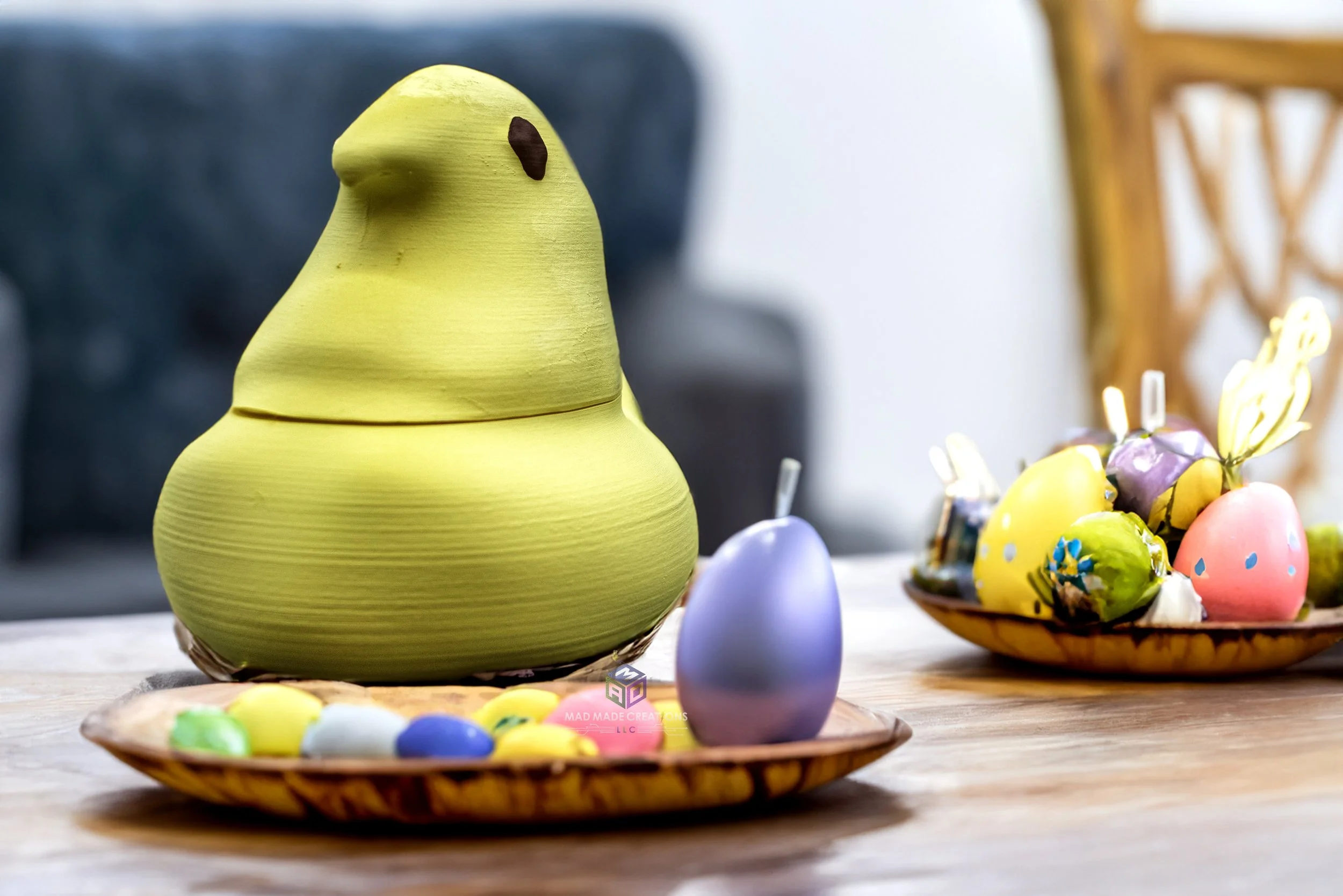 Yellow 3D printed Easter chick candy dish displayed on a festive table with colorful eggs and candles, handmade by MAD Made Creations, perfect for holiday decor or treats