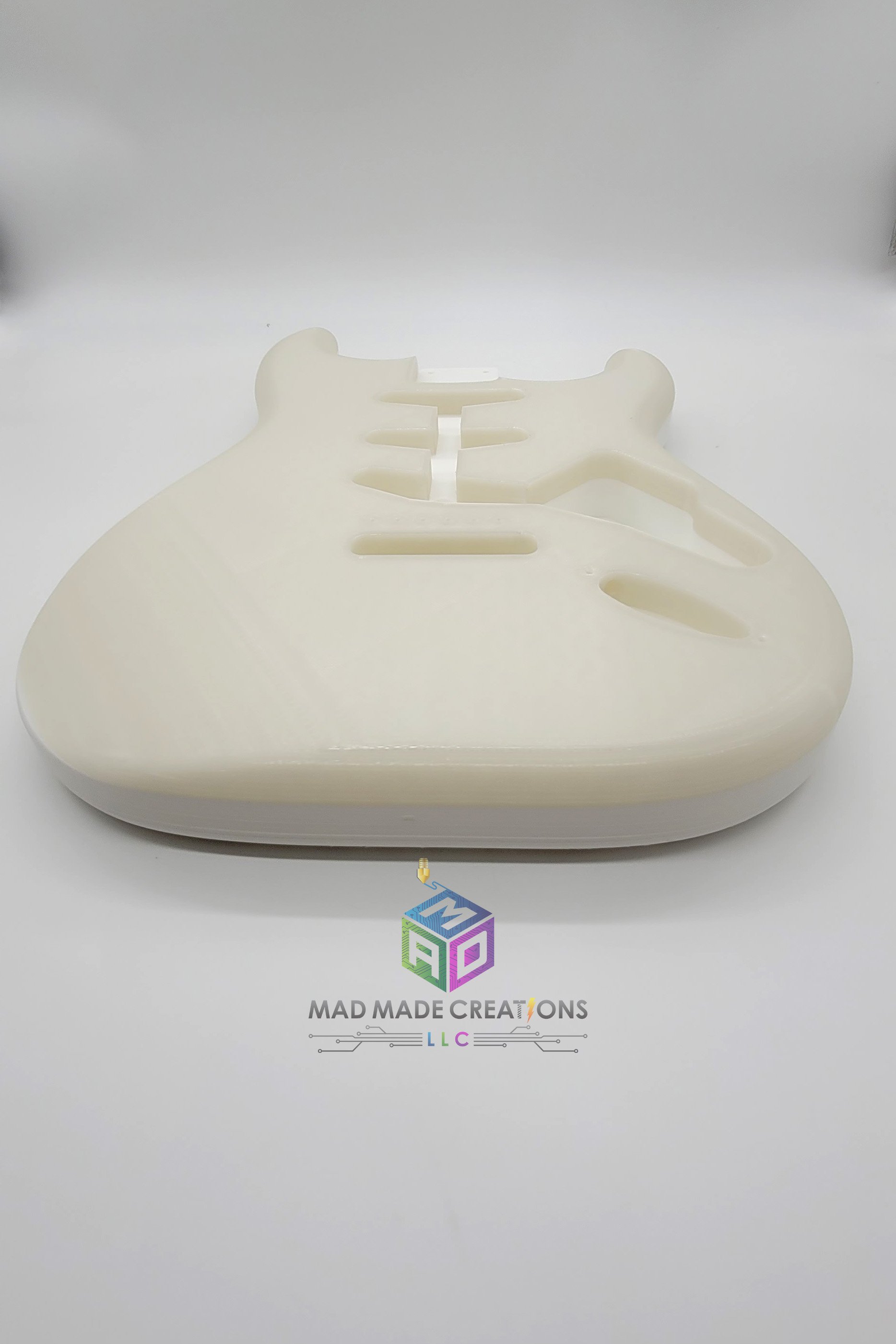 Front long view of Strat SSS style guitar body – custom one-piece 3D printed guitar made with glow-in-the-dark blue filament by MAD Made Creations