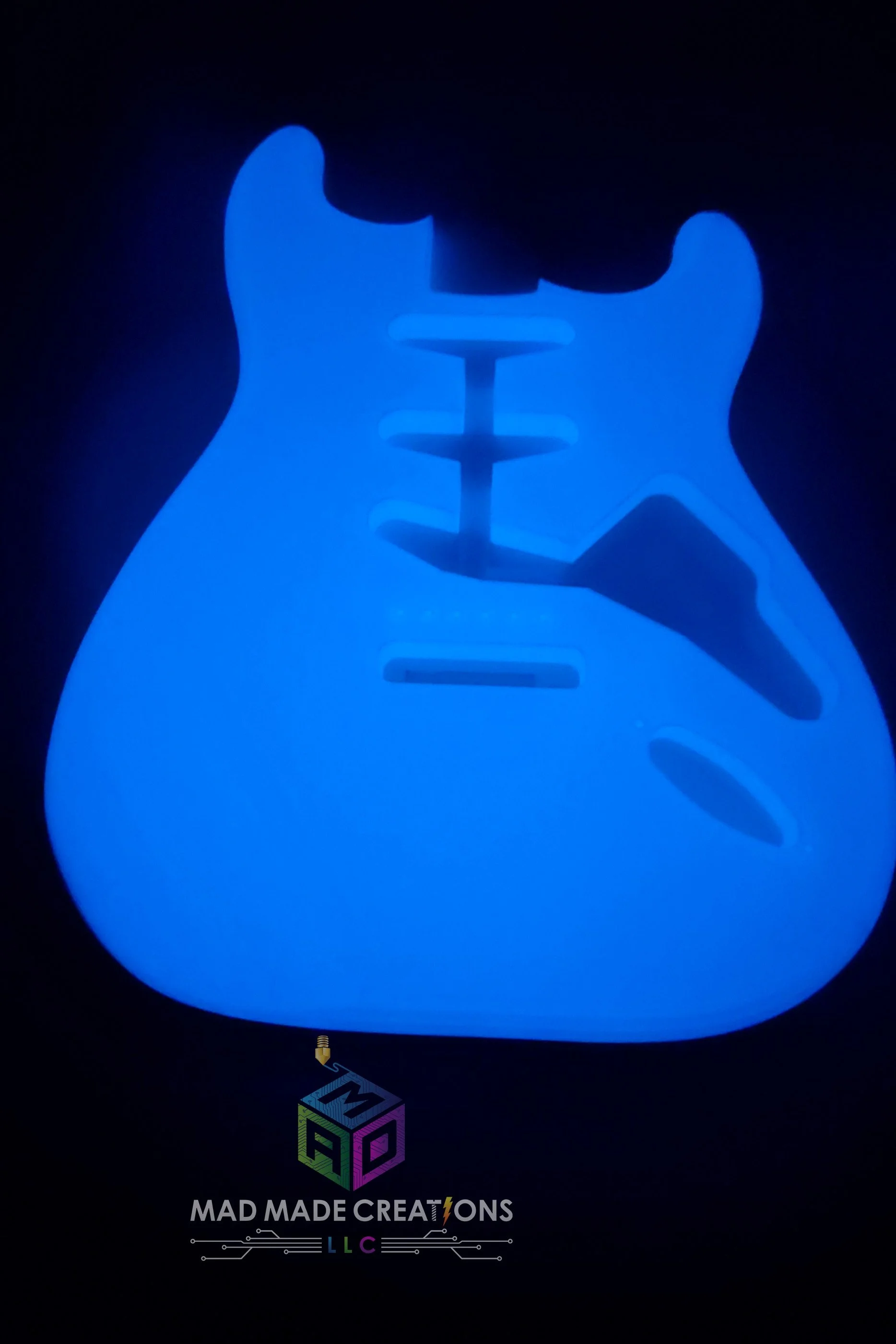 Front view of glowing blue Strat SSS style guitar body – custom one-piece 3D printed glow-in-the-dark guitar body by MAD Made Creations