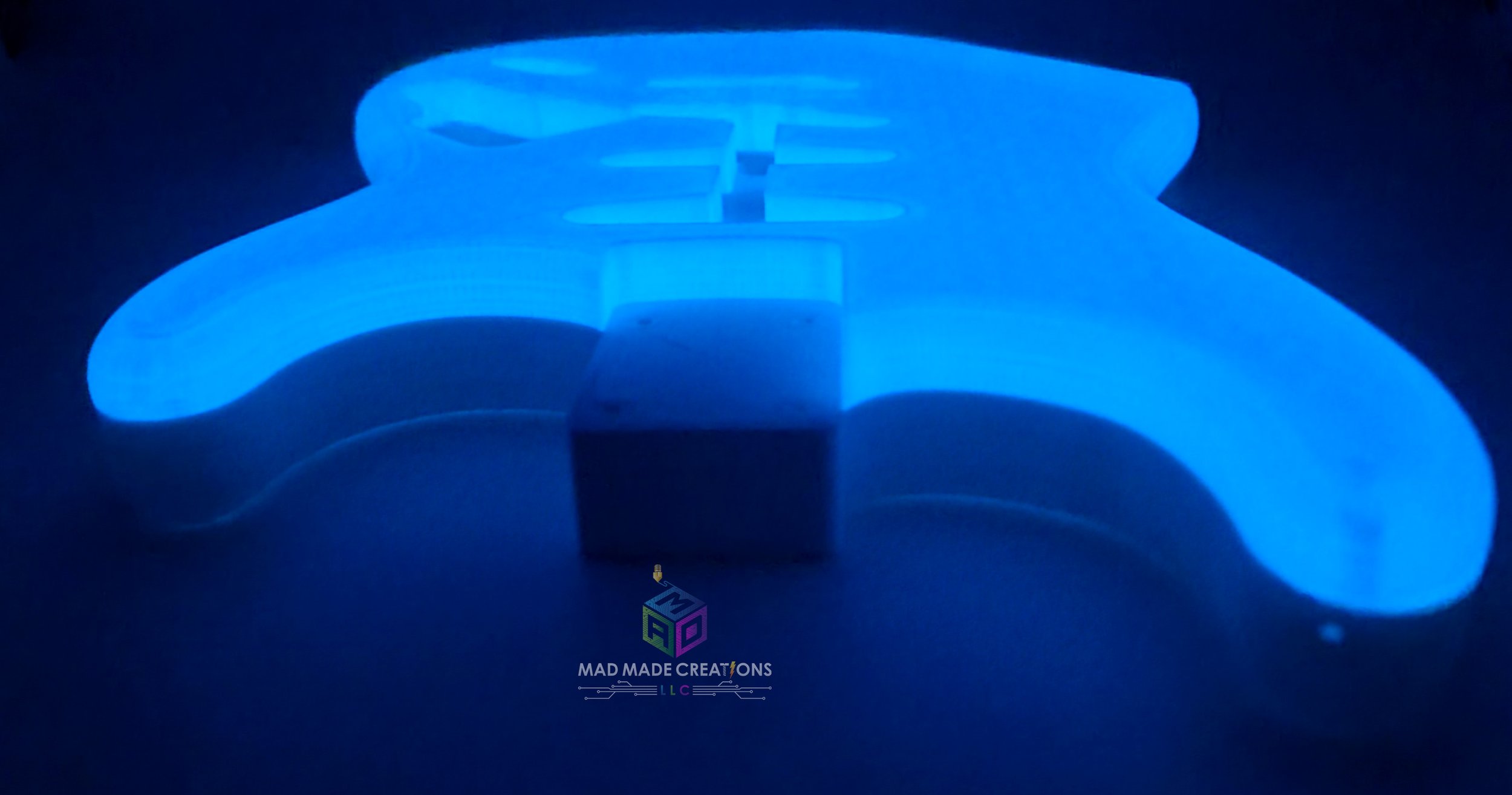 Glowing blue Strat SSS style guitar body viewed from front top angle – custom one-piece 3D printed glow-in-the-dark guitar body by MAD Made Creations