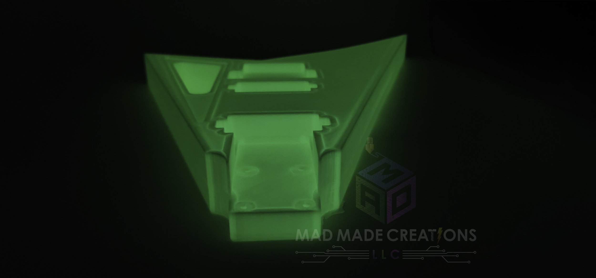 Close-up front neck view of glowing green 3D-printed Randy Rhoads V-style guitar body featuring HH pickup routing and Floyd Rose compatibility
