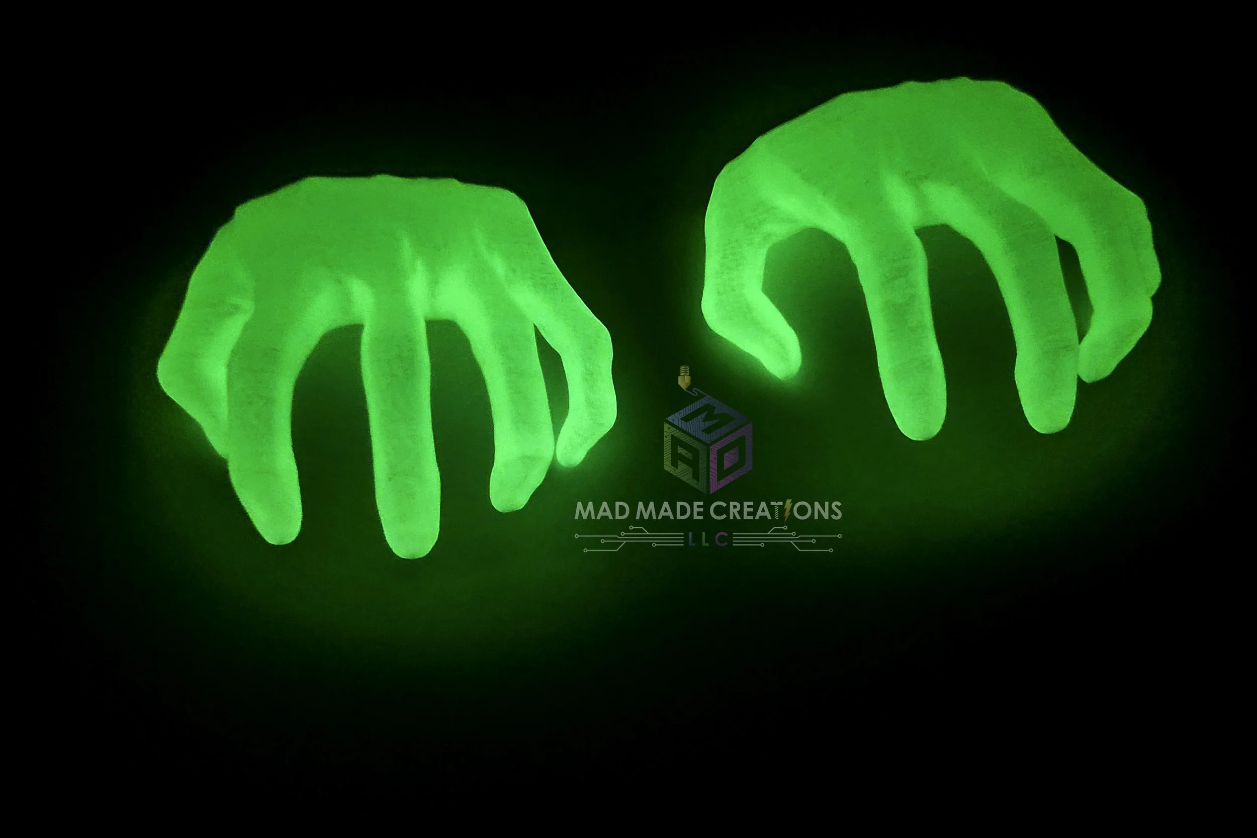 Pair of 3D printed glowing green ghost hands by MAD Made Creations, designed as hangable Halloween decorations for spooky home or yard setups