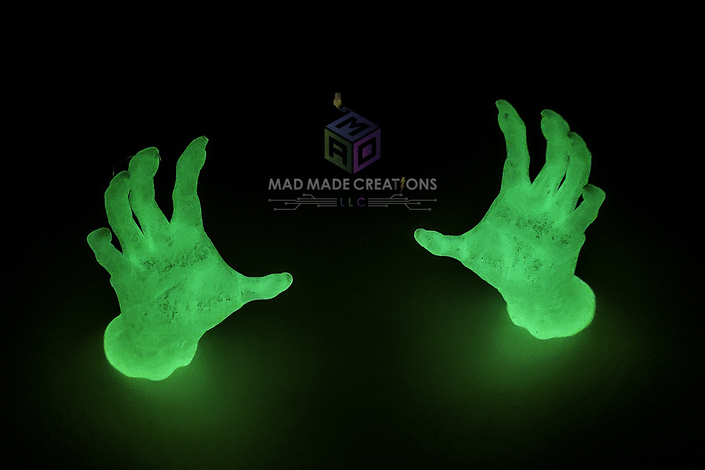 Pair of eerie green glowing 3D printed demon hands for hanging Halloween decorations by MAD Made Creations LLC, perfect for haunted house or yard setups