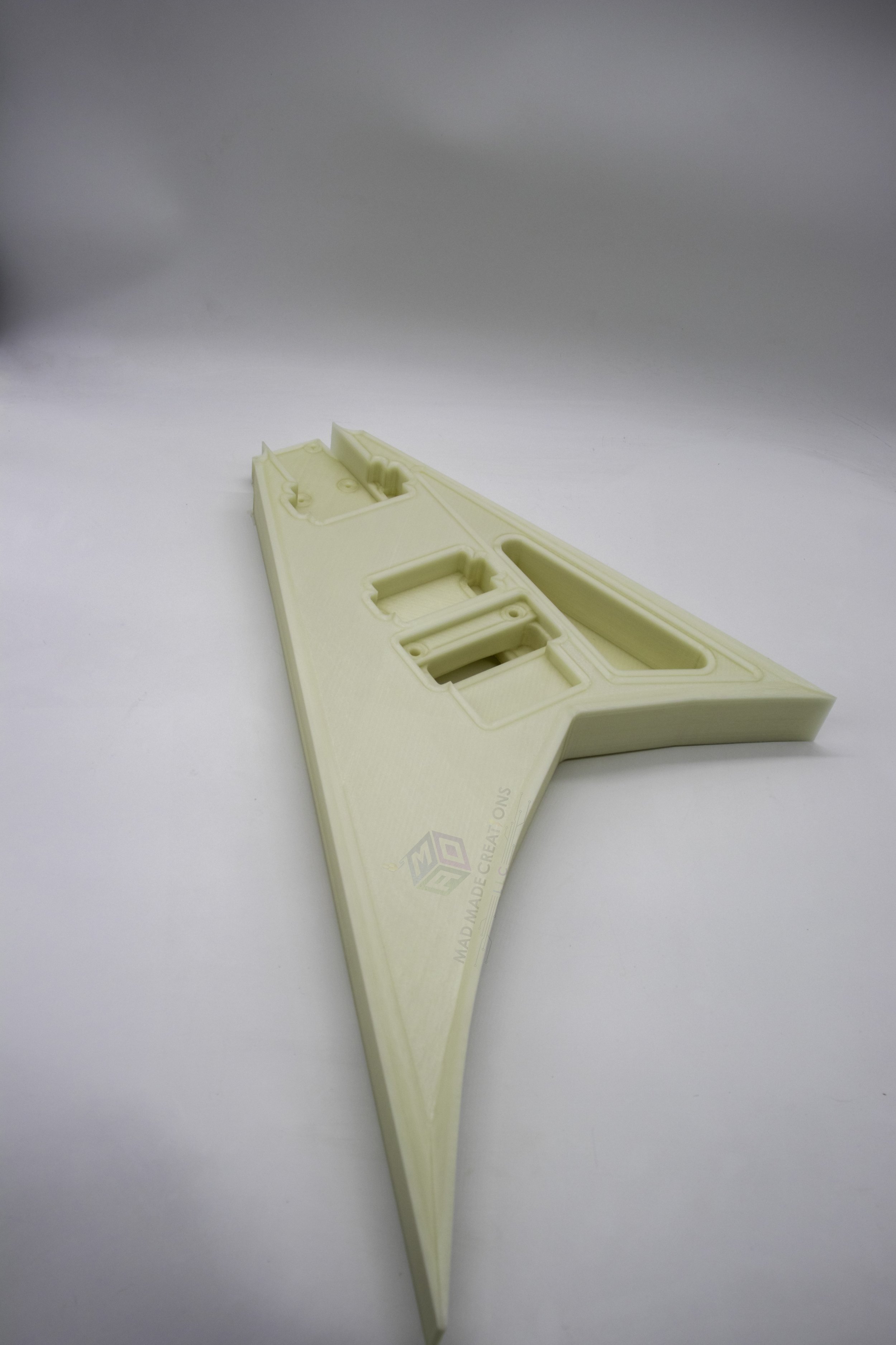 Top front view of a 3D-printed Randy Rhoads V-style guitar body in natural glow-in-the-dark finish, showcasing HH pickup routing and Floyd Rose tremolo compatibility