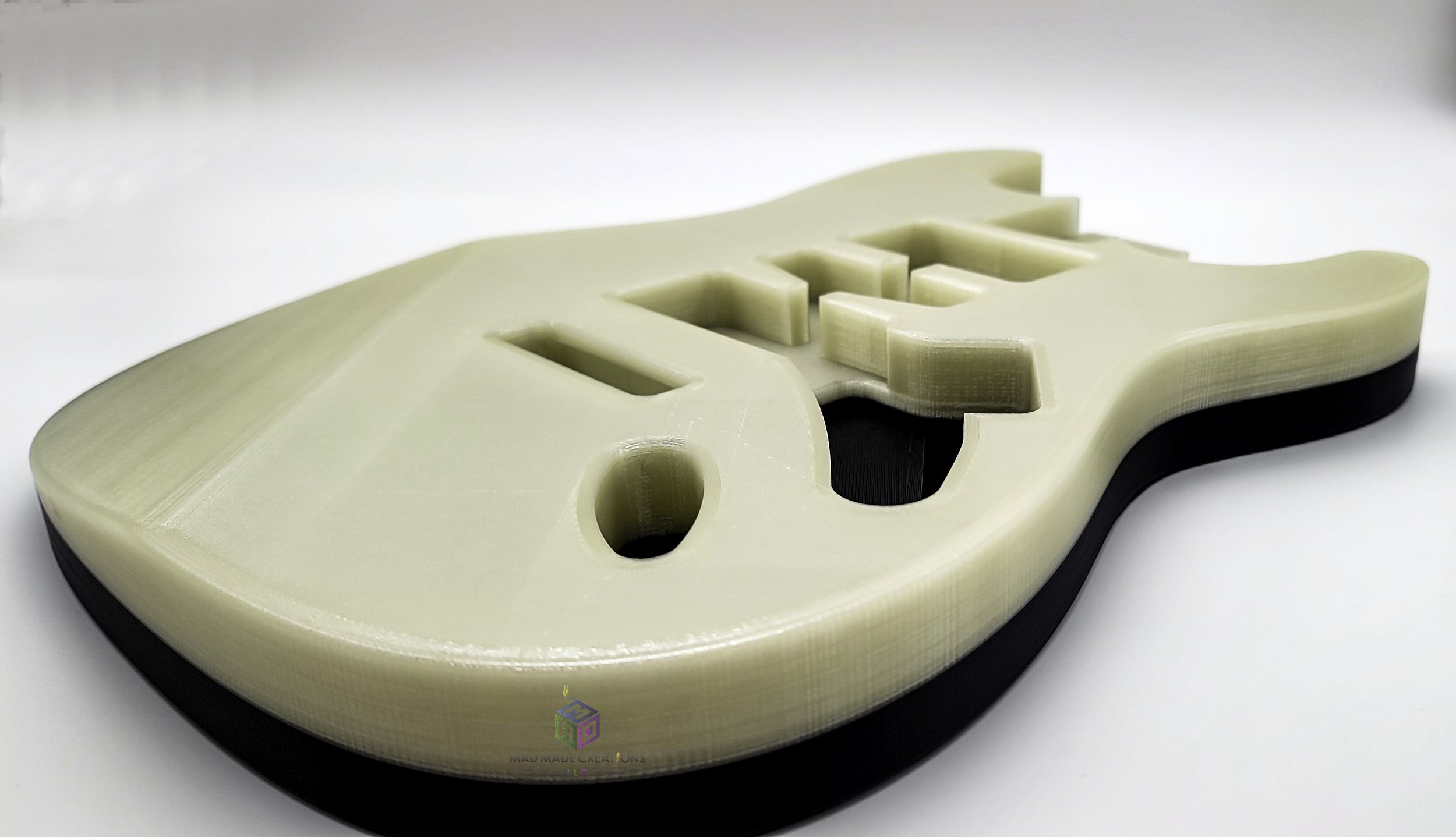 Close-up side view of custom Strat HSH style 3D printed guitar body in non-glowing state, featuring glow-in-the-dark filament and modern 2-post tremolo mount by MAD Made Creations