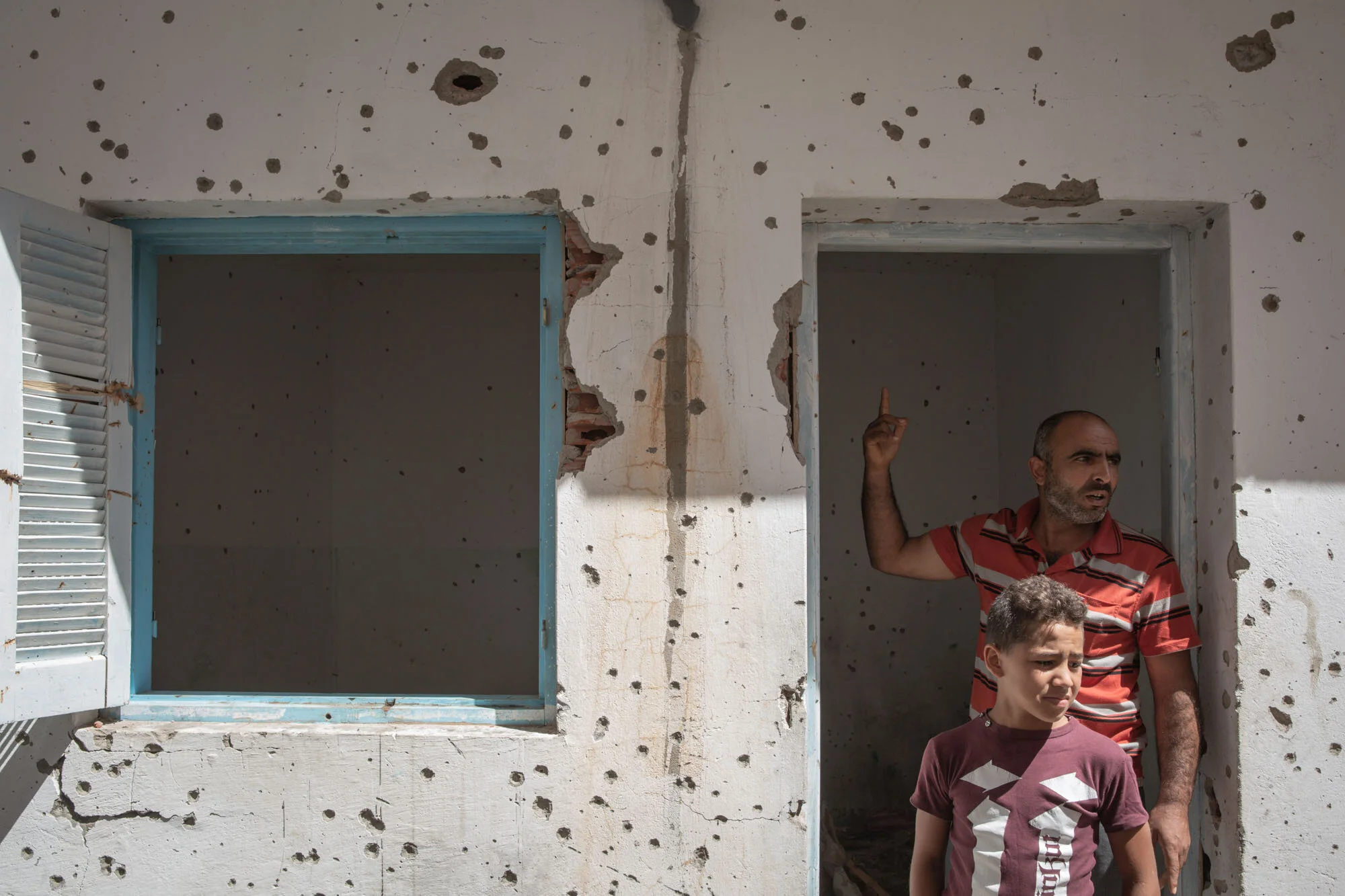 Extremism is no stranger to Tunisia. Two Tunisians visit a house damaged during a shootout between the army and suspected terrorists in their hometown