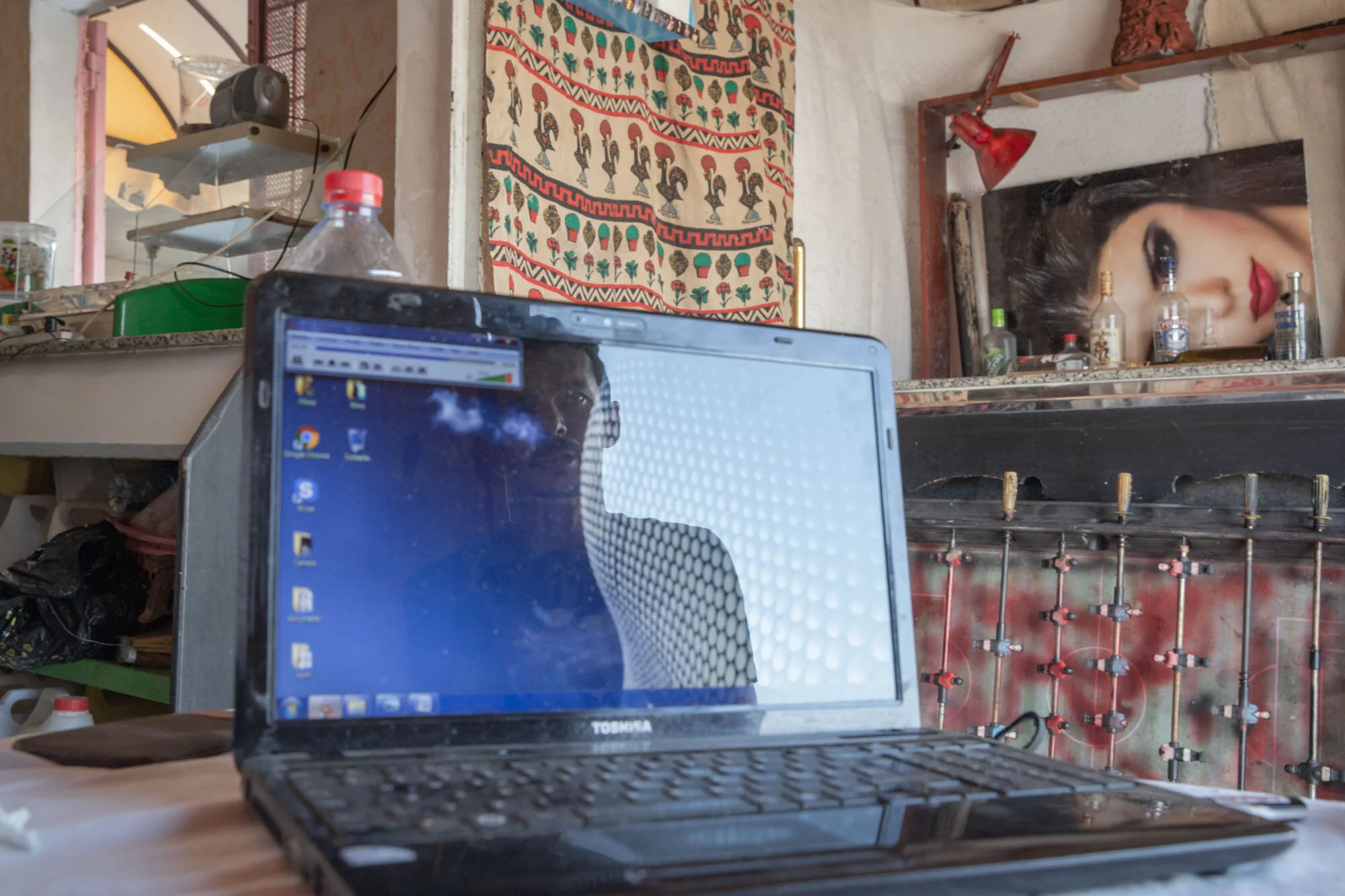 Ahmed Sassi sits in his family’s store in El Kabaria, one of the poorer neighborhoods of Tunis
