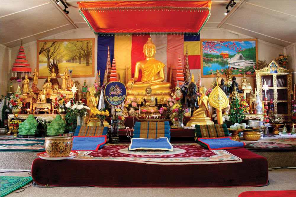 The altar at Wat Lao Sayaphoum is resplendent with a large central Buddha donated by the Phapphayboun family and countless other items given by the community. 