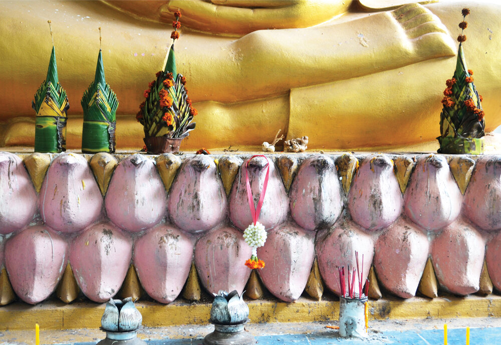 Food is central to giving, and giving is central to Buddhism. Garlic and ginger placed at Buddha’s feet underlines the connections between food and Buddhism. (Vientiane, Laos)   