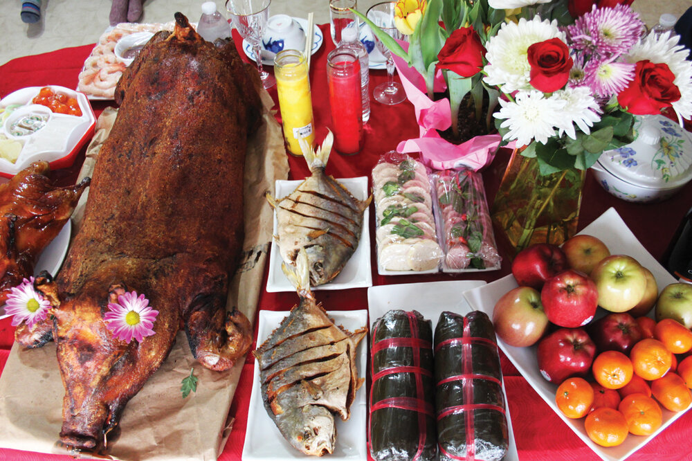 The Phapphayboun celebrate Vietnamese New Year (Têt) to honor Noubath’s father. The centerpiece of the family table is always a whole barbecue pig. 