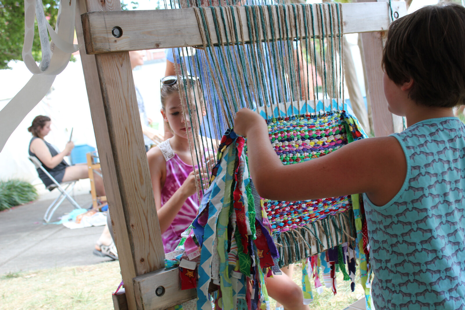 National Folk Festival visitors help "weave the tent" with artist Jo Israelson for her Welcoming the Stranger project. 