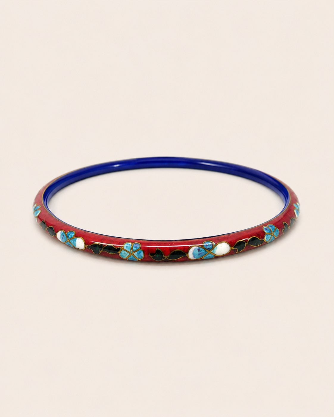 Vintage red ground cloisonné bangle with blue and white floral enamel.