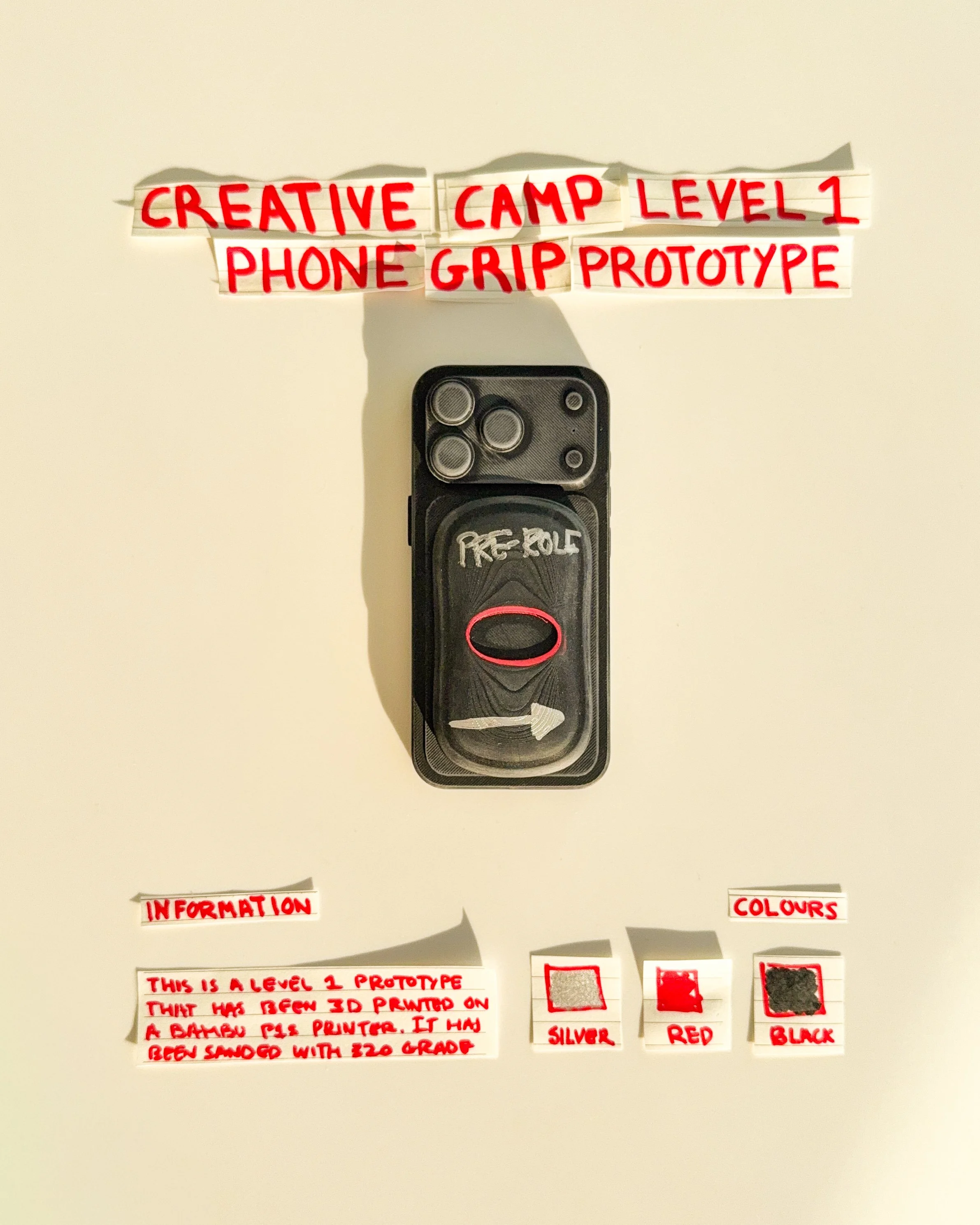 day 19 prototype 17: develop a white rectangular phone grip featuring custom lettering, directional graphics and red accents. the design explores how simple typography can create a recognizable visual identity.