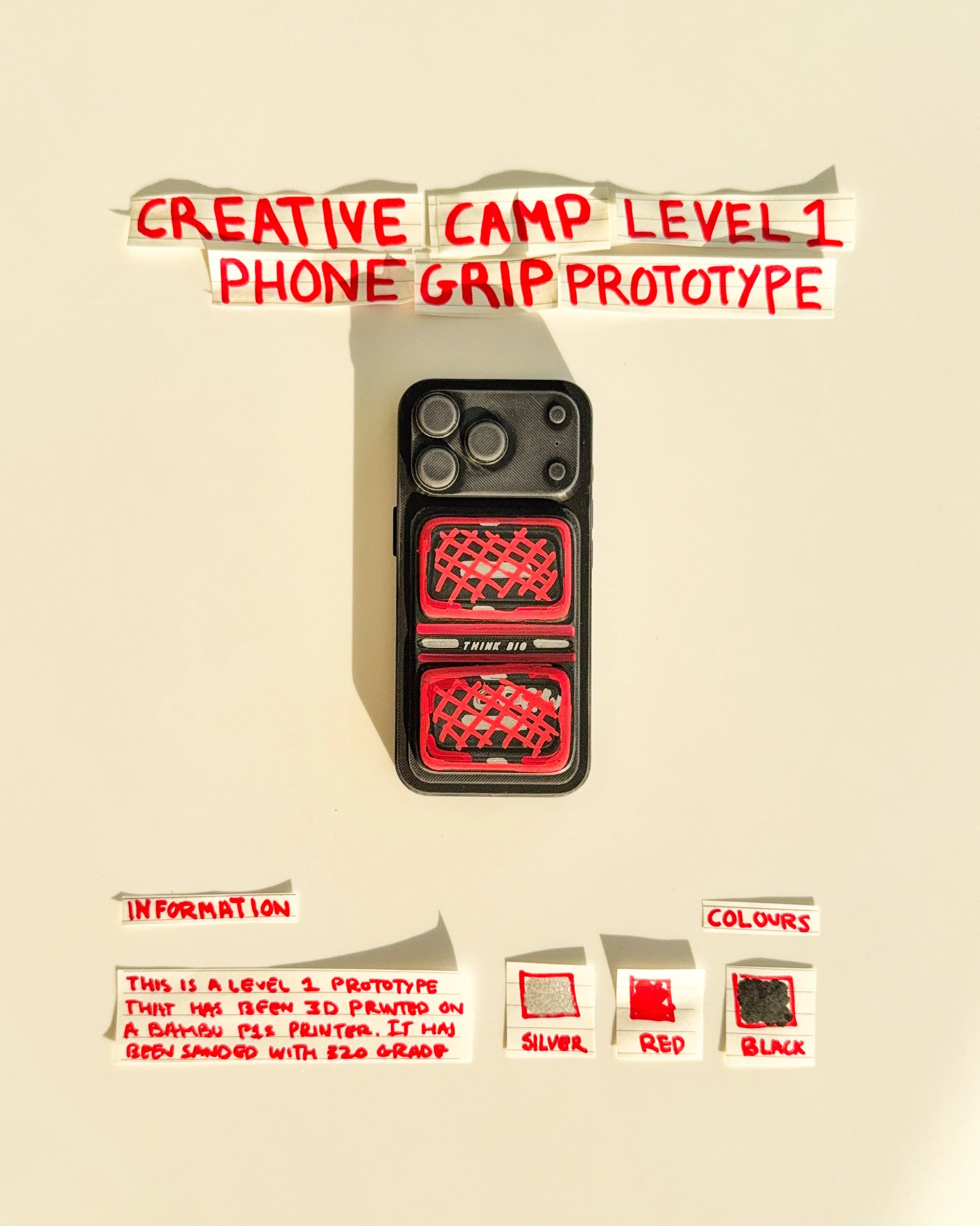 day 15 prototype 13: explore a rectangular phone grip with a narrow horizontal opening and handwritten typography. the design combines a simplified functional shape with graphic experimentation.