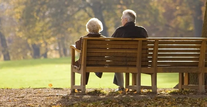 Elderly Couple Sitting on Park Bench