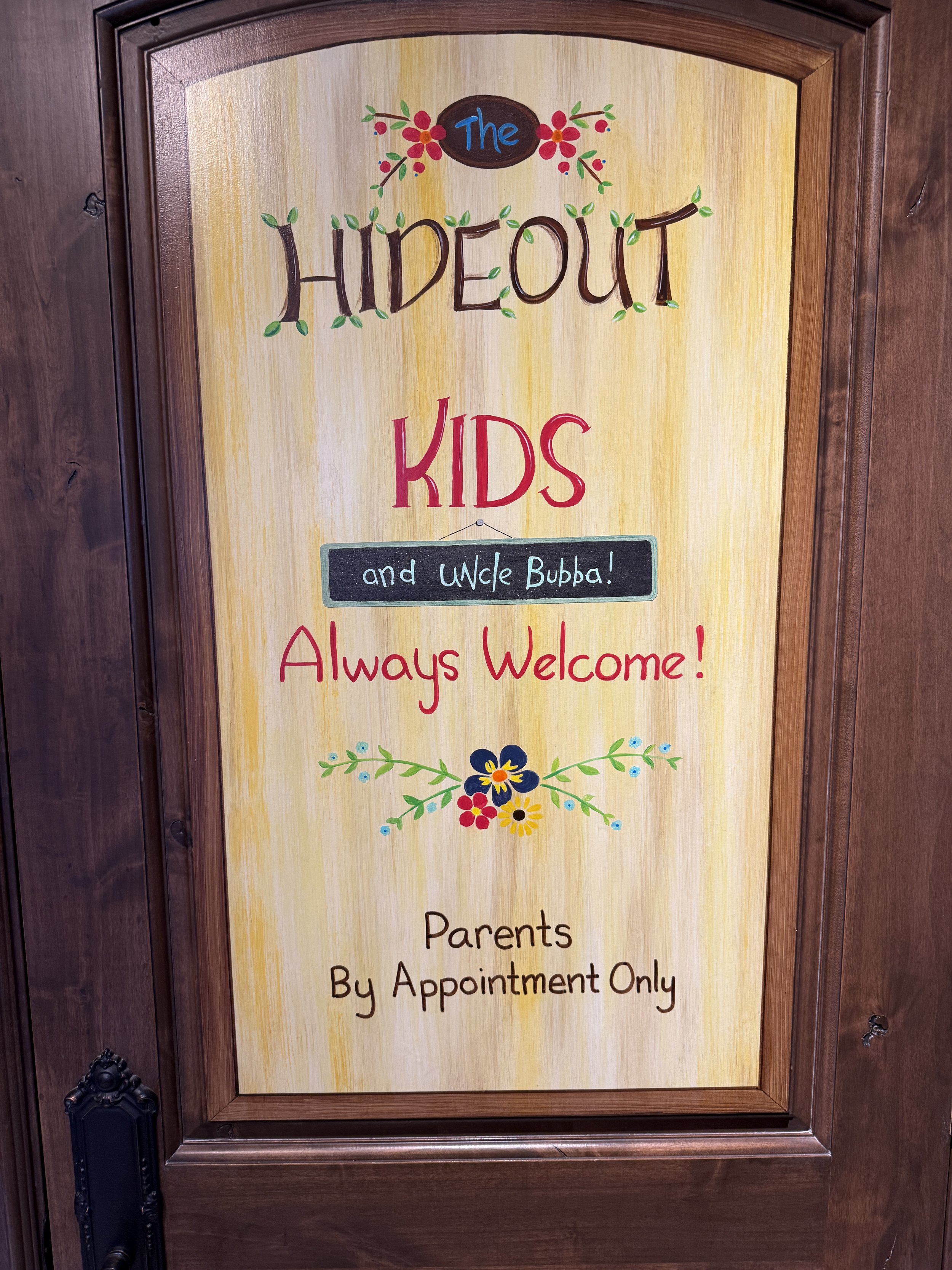 Kids under the stairs hideout sign done on peal and stick canvas to preserve door.