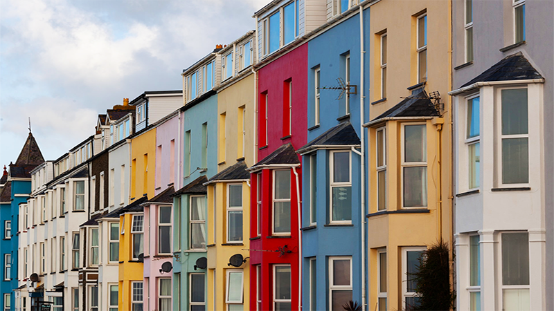 This image is clickable. Colorful terraced houses on the road