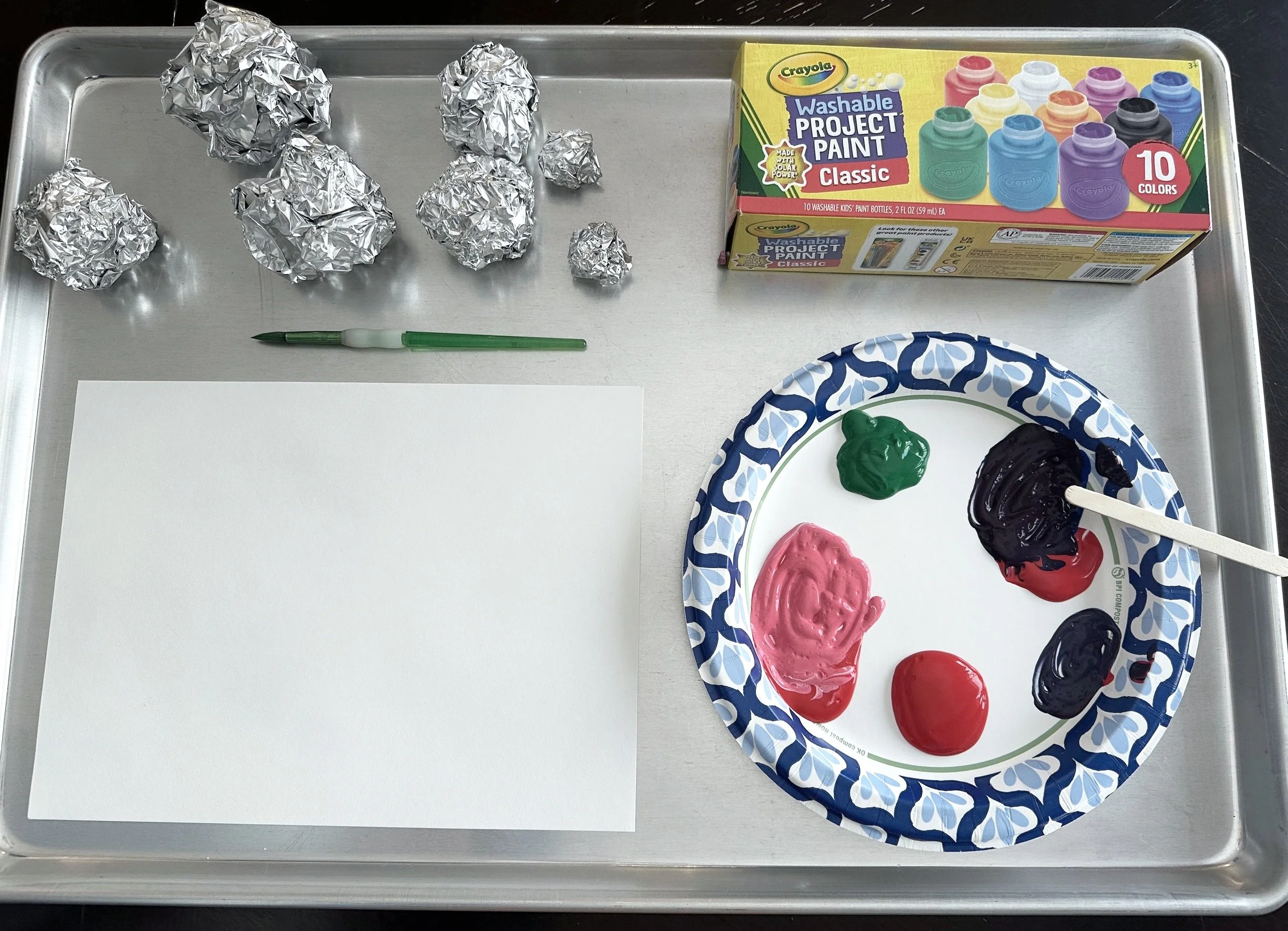tempera paint in green and pink and balls of aluminum foil
