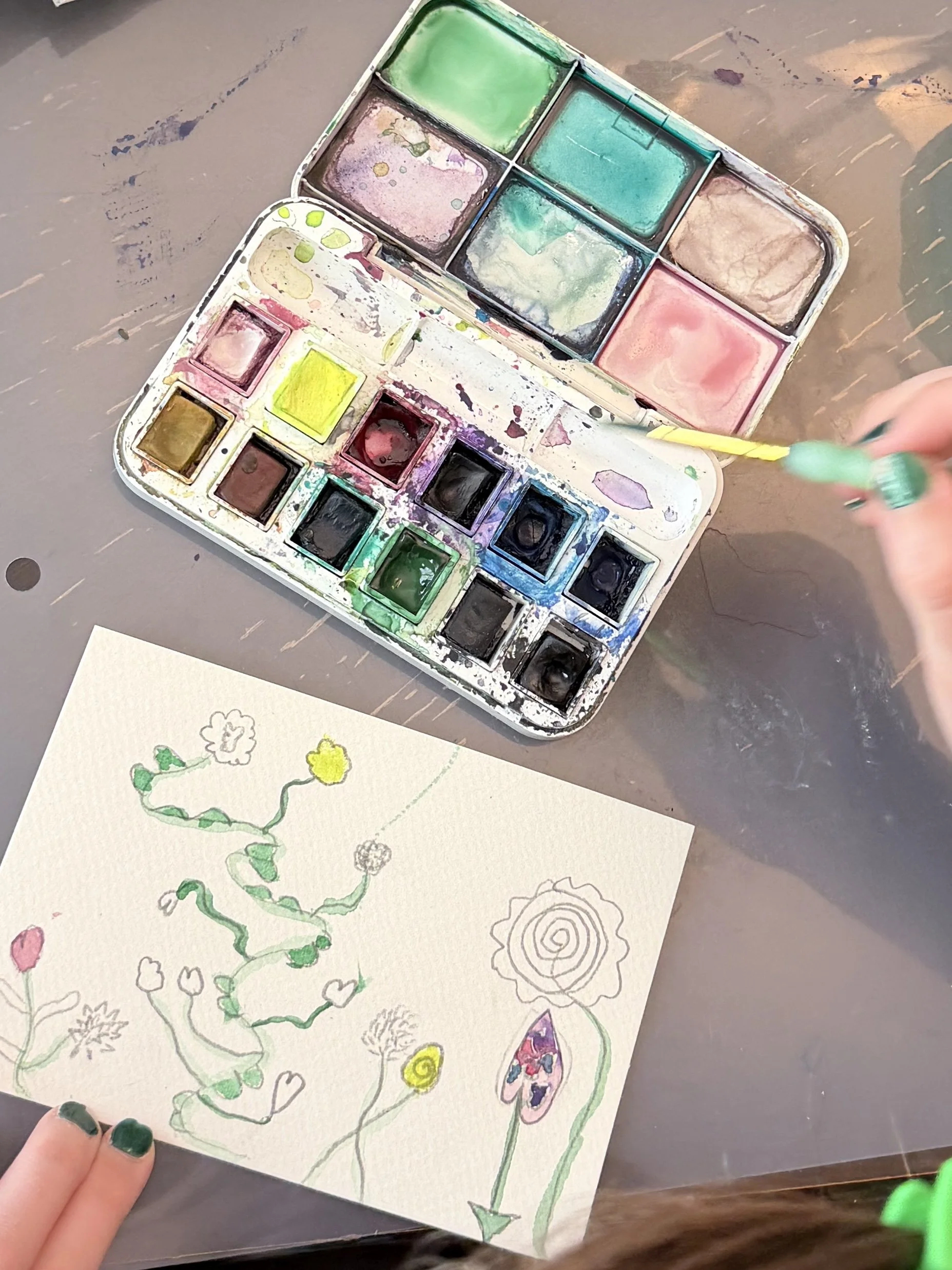 kid painting of wildflowers with watercolor