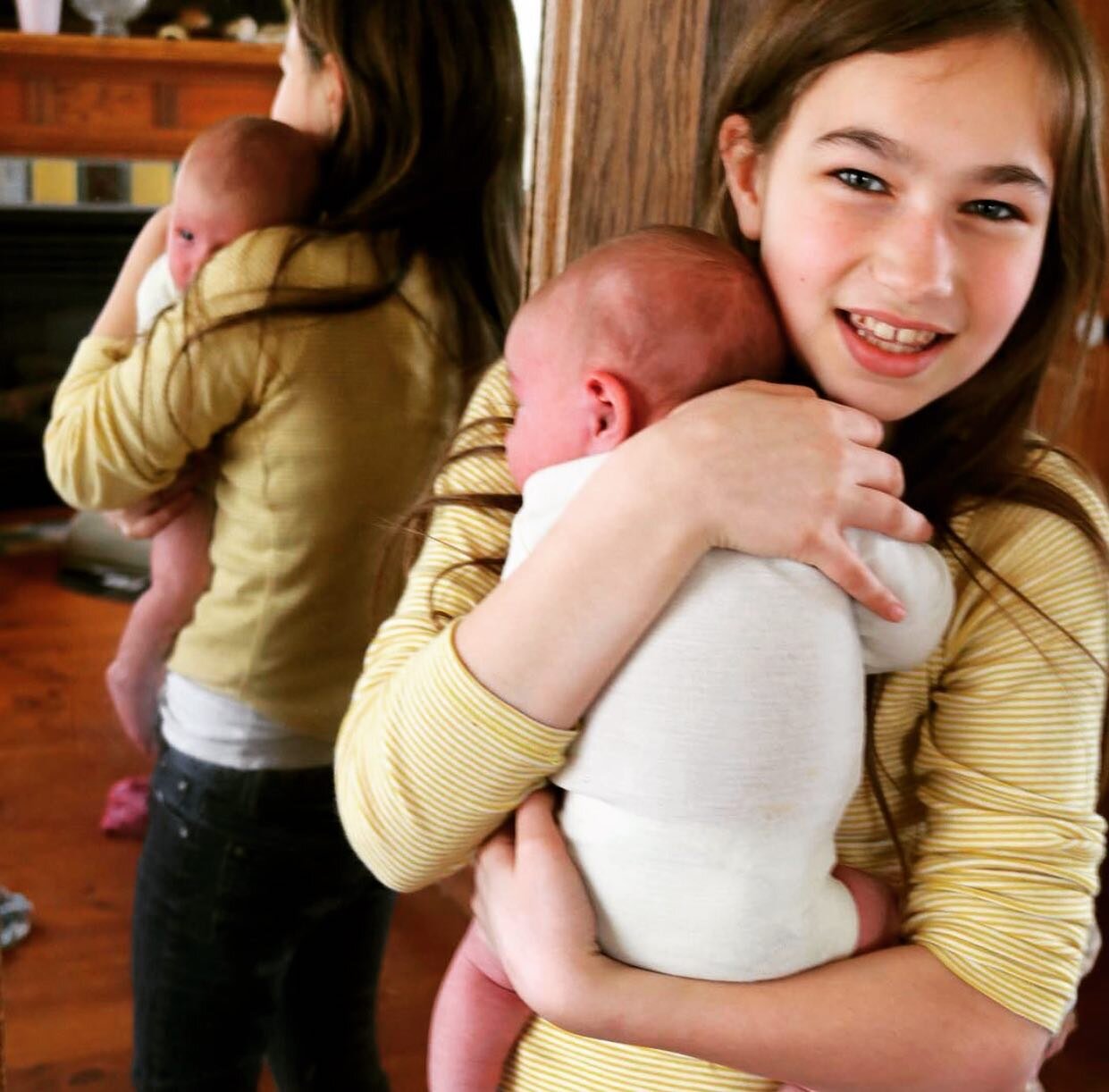 #4 big sister securely cuddling #9 little sister, and getting it just right!

Babies love it when their hips, shoulders and head are all stable. See how baby has snuggled right into the contours of her sister&rsquo;s warm body?

This kind of firm, co