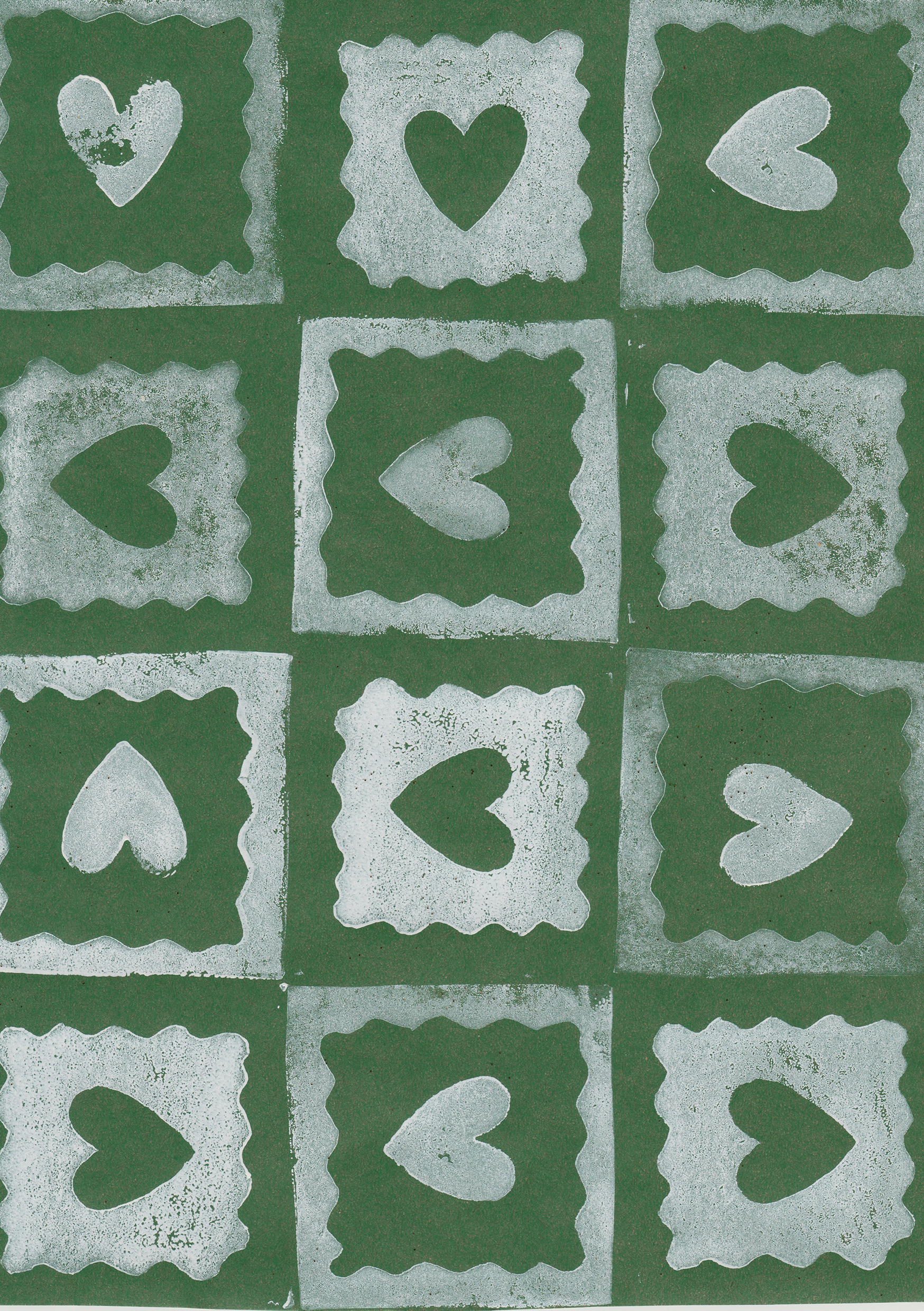 A pattern of square tiles with scalloped edges on a green background, each with a heart shape cut out in the center.