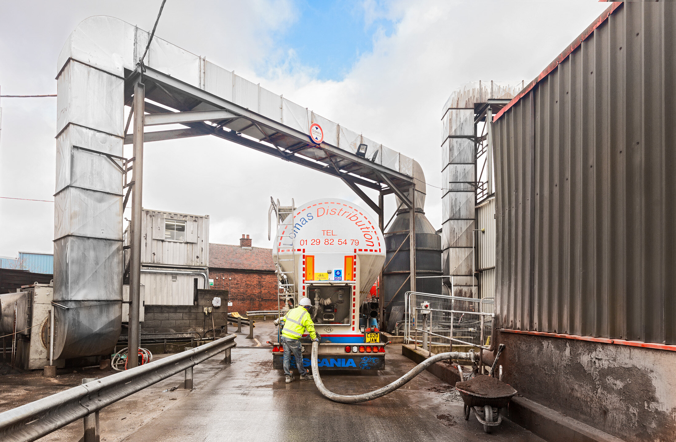 Grey lorry tanker with collected liquid waste for treatment at a UK hazardous waste management company in Derbyshire