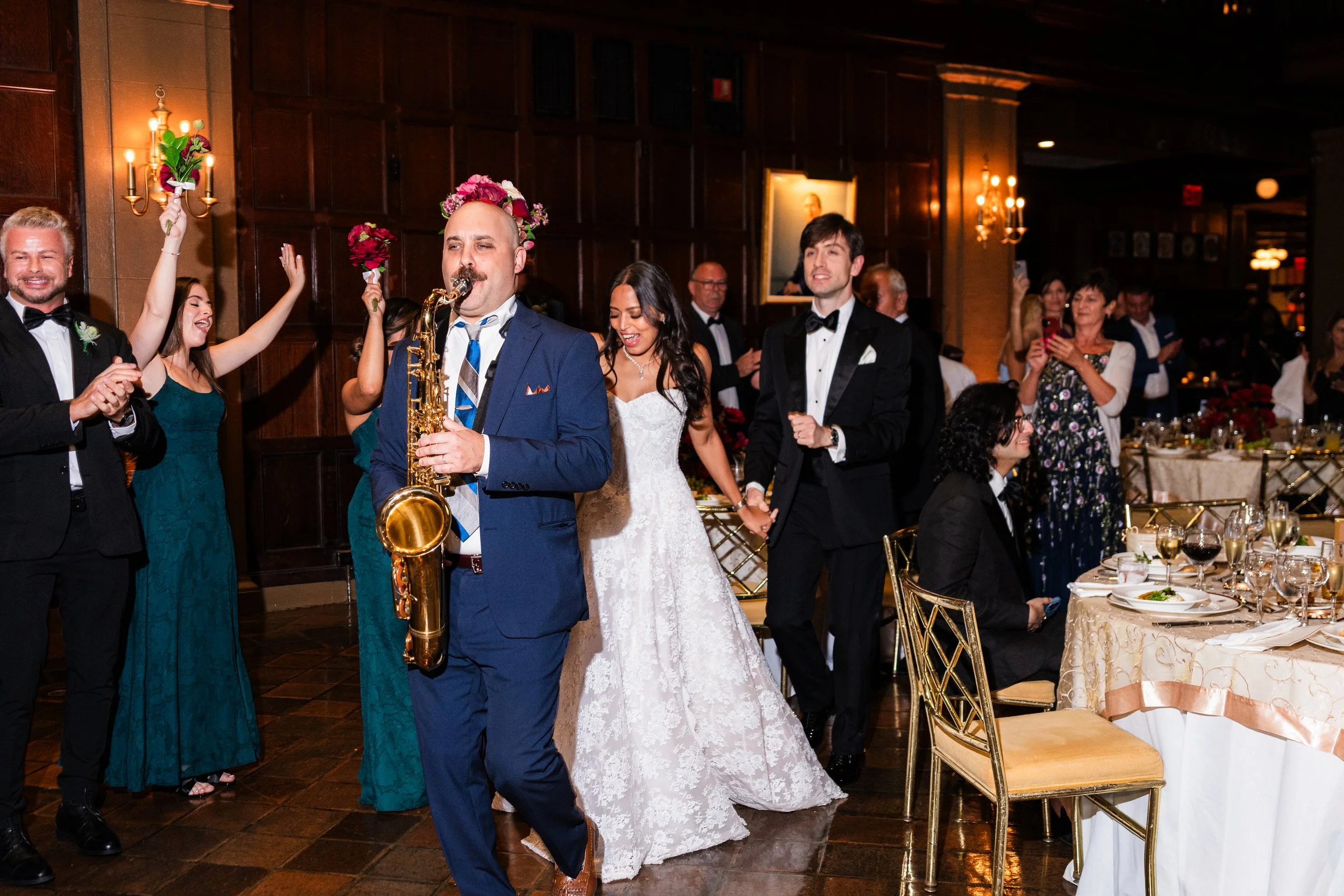 Charlie Roman Jazz Band saxophonist playing as he leads the bride and groom during their grand entrance at the Harvard Club of New York City.