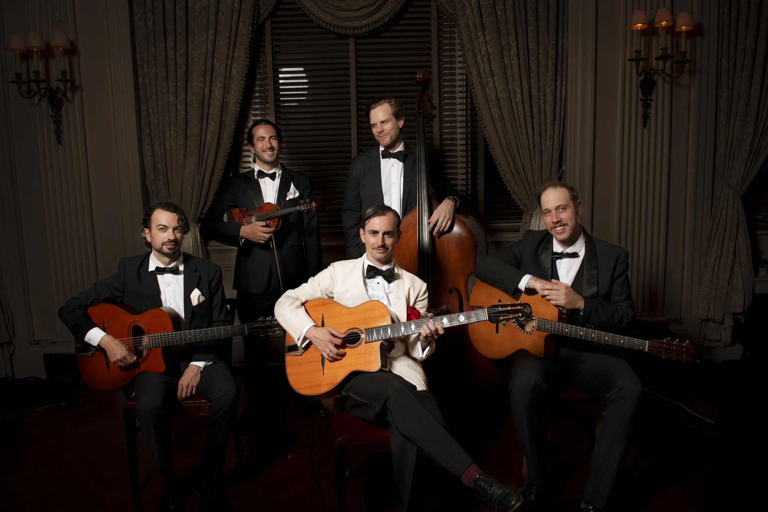 Charlie Roman Jazz Band performing Hot Club-style French Gypsy jazz in New York City with guitars, violin, and upright bass.