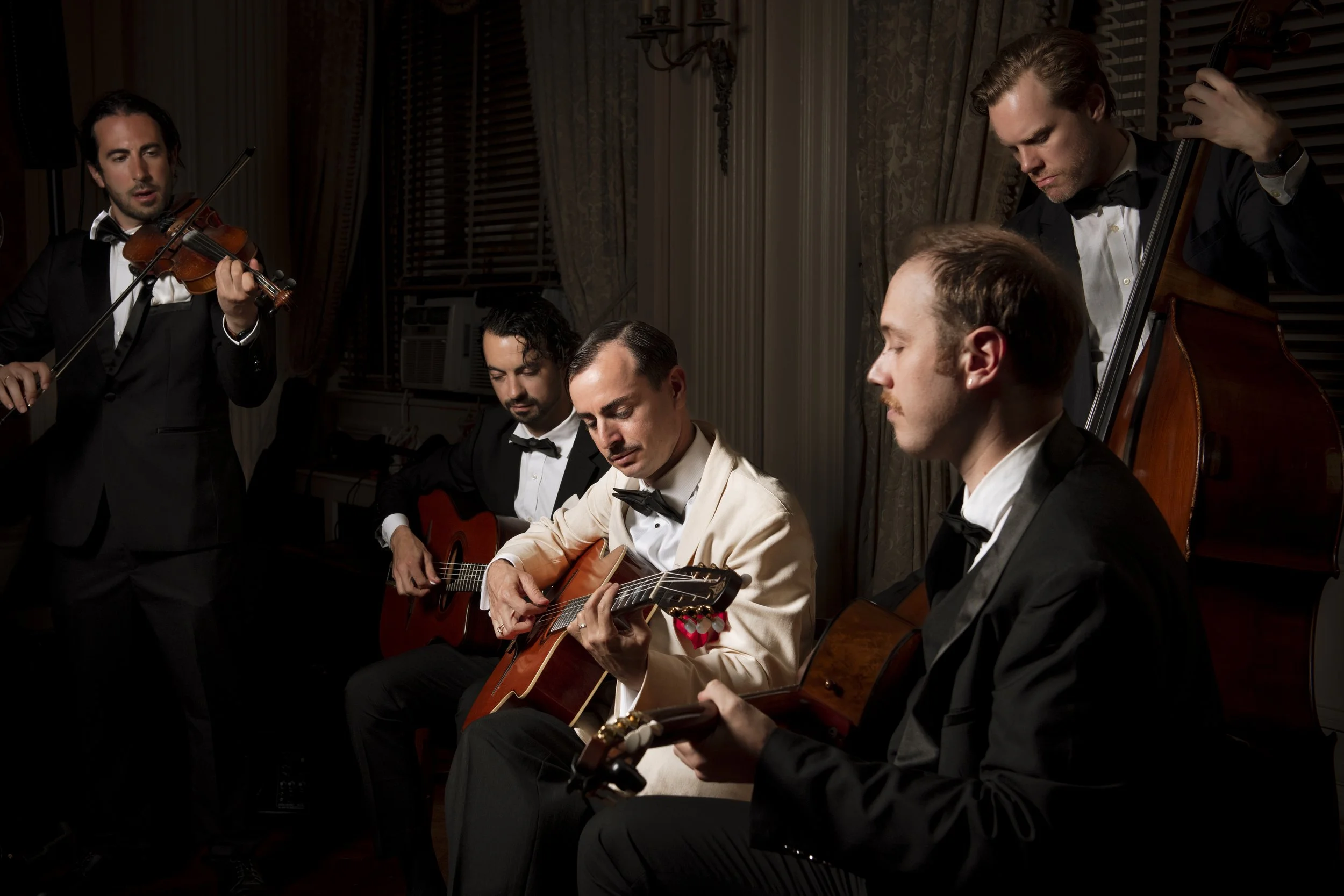 Five- piece vintage jazz band performing at an elegant New York wedding, featuring violin, guitars, and upright bass.