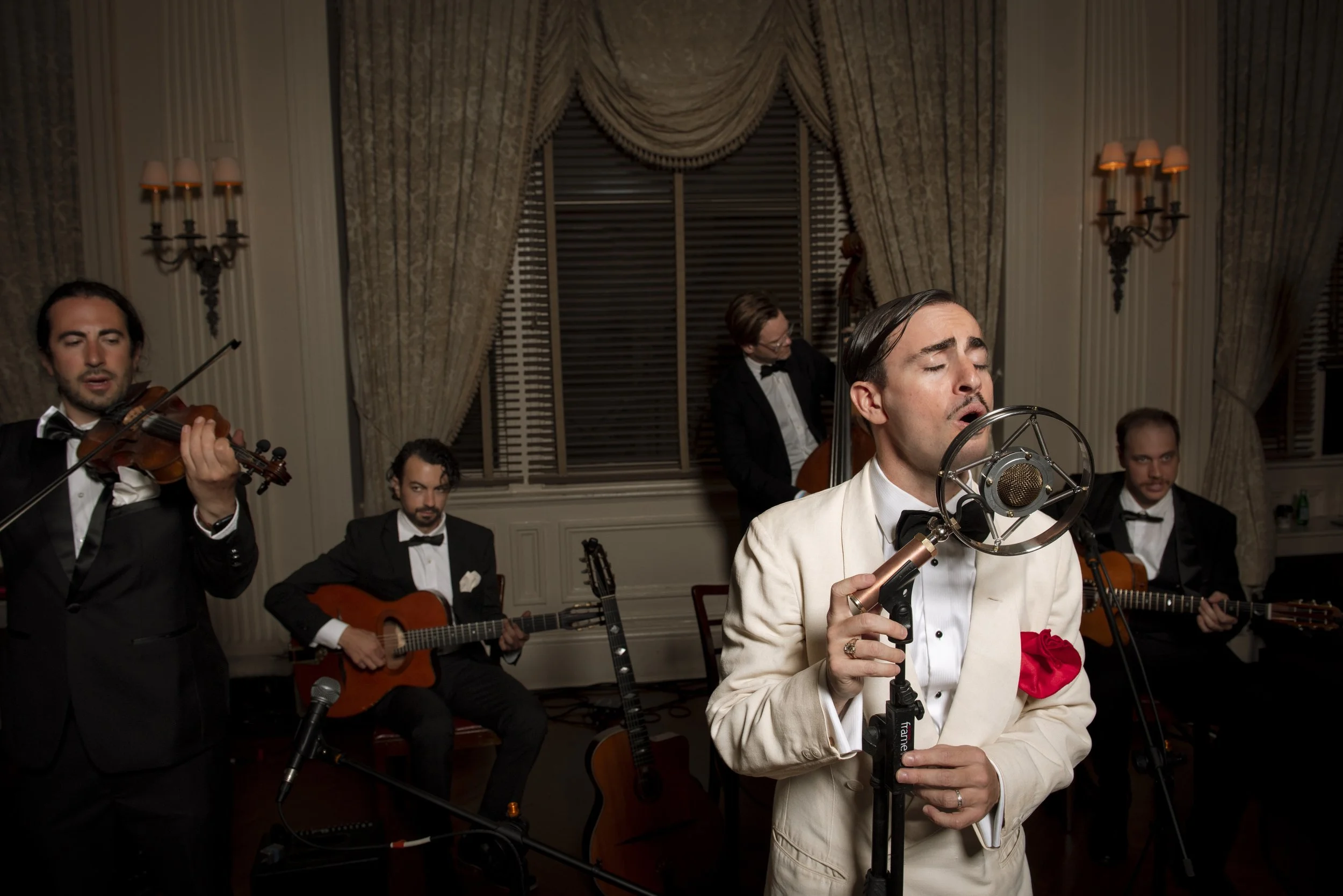 Charlie Roman Jazz Band performing vintage and Gypsy Jazz with violin, guitars and upright bass at a formal event in New York City