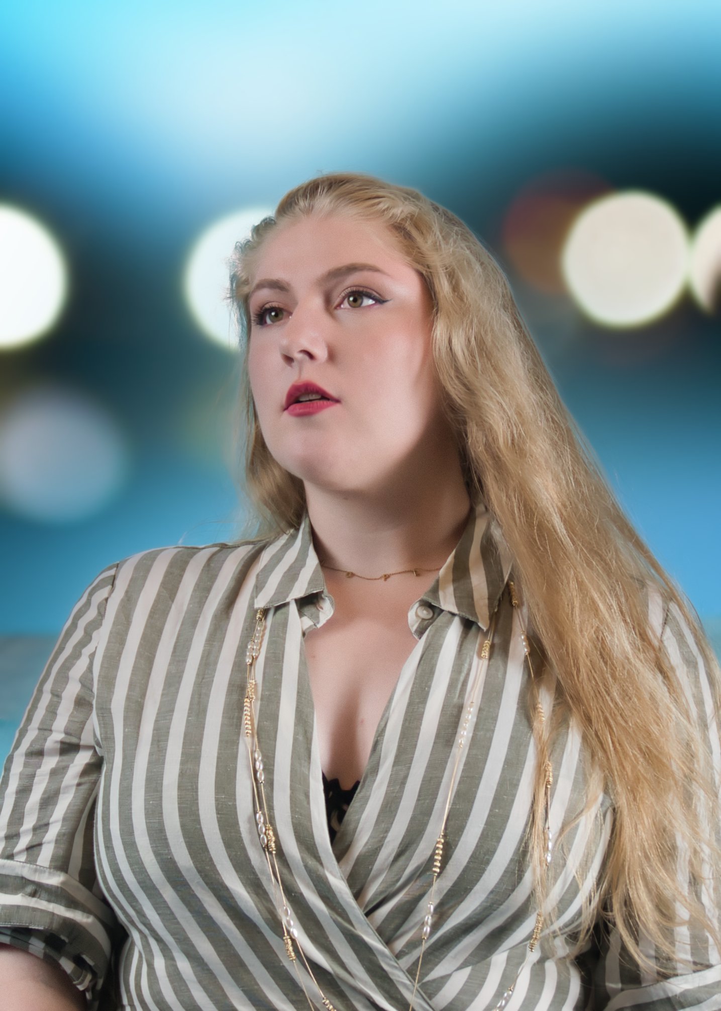 Woman posing looking into the distance with blue and white circles in the background