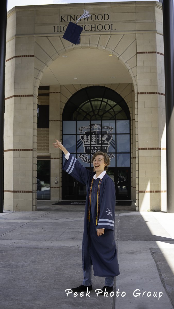 Young man tossed mortar board into sky in front of high school
