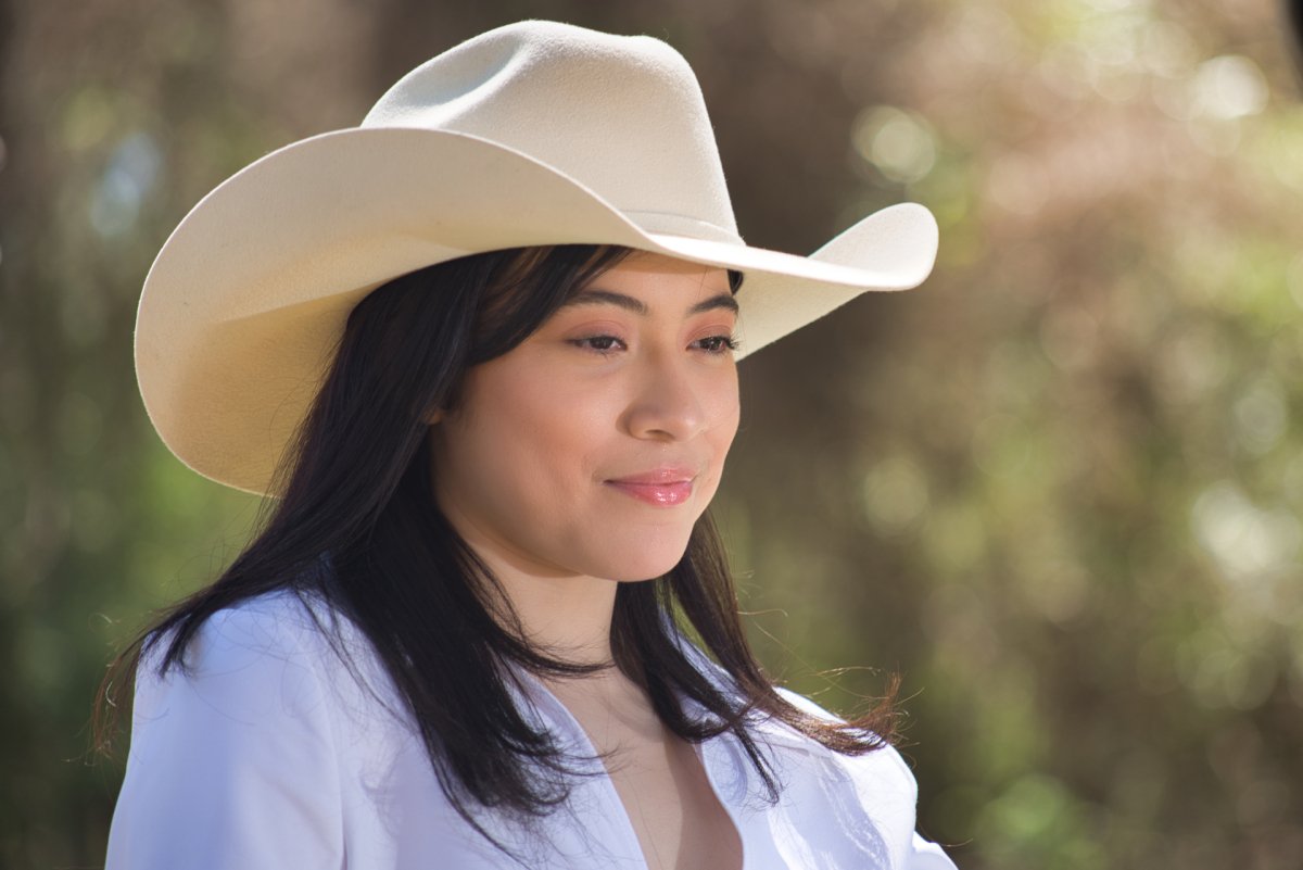 Young cowgirl looking into the woods