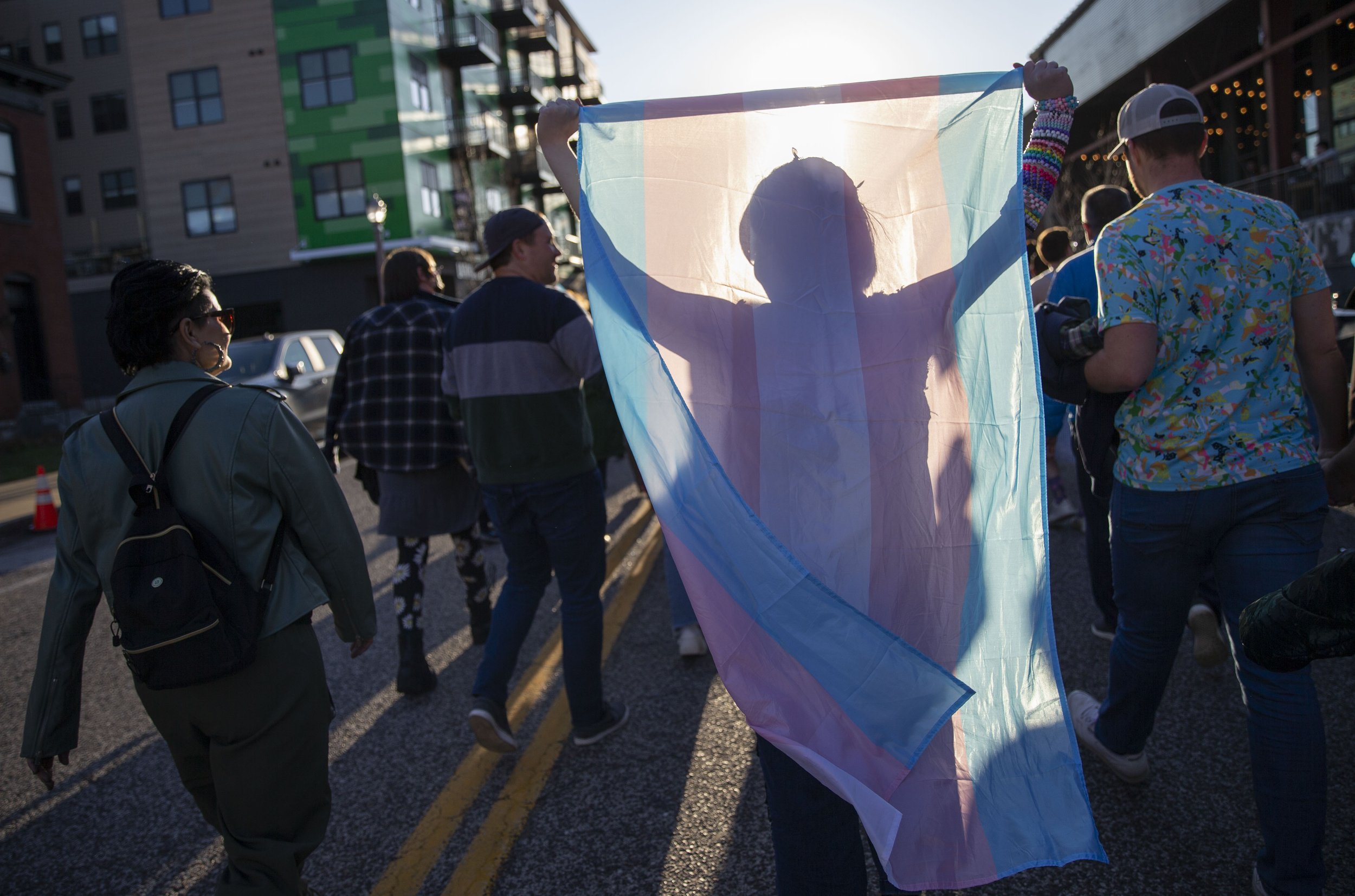  An activist carries a transgender flag during a solidarity march Saturday, March 25, 2023, along Manchester Avenue in the Grove neighborhood. Activists, organized by group “It's all drag!,” marched in response to nationwide legislation, including dr