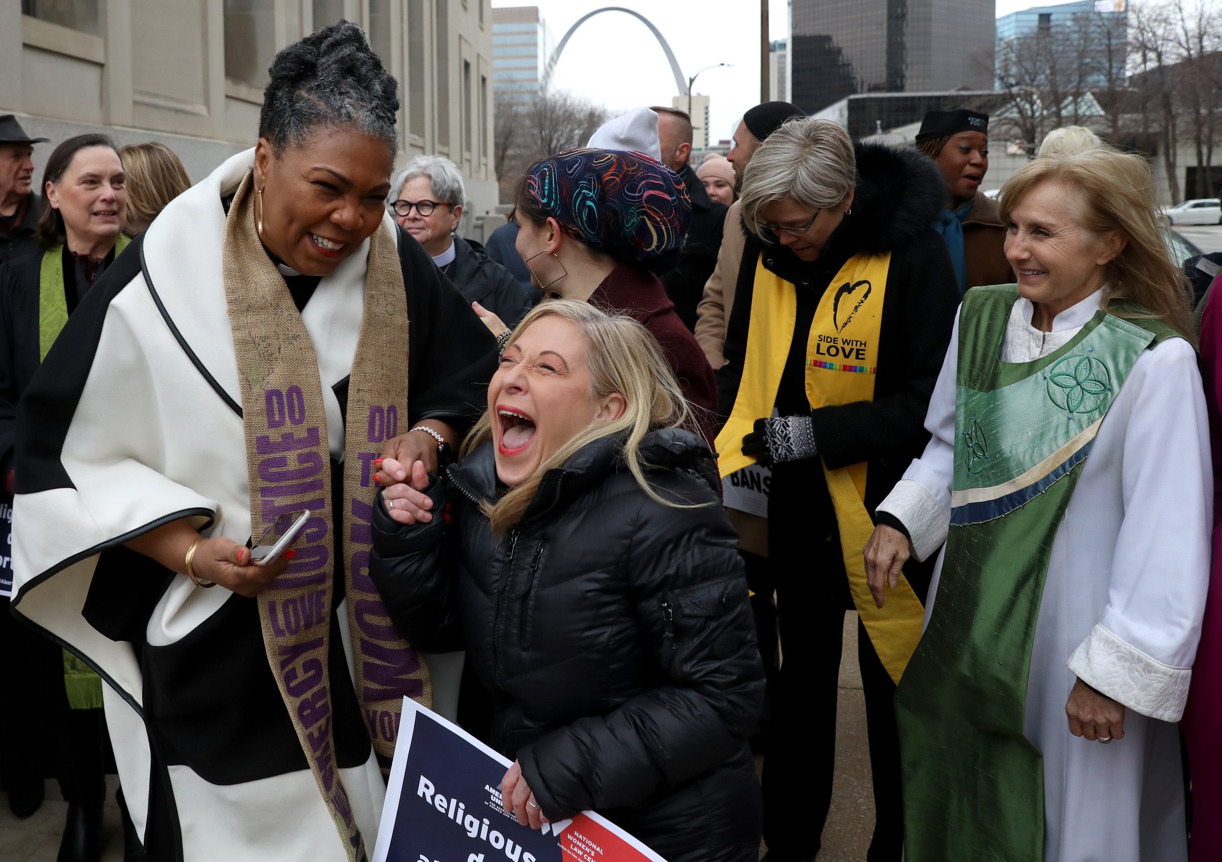  The Rev. Traci Blackmon of the United Church of Christ, left, laughs with attorney Denise Lieberman, right, after the group walks to the Civil Courts building following a press conference announcing a lawsuit challenging Missouri's abortion ban on T