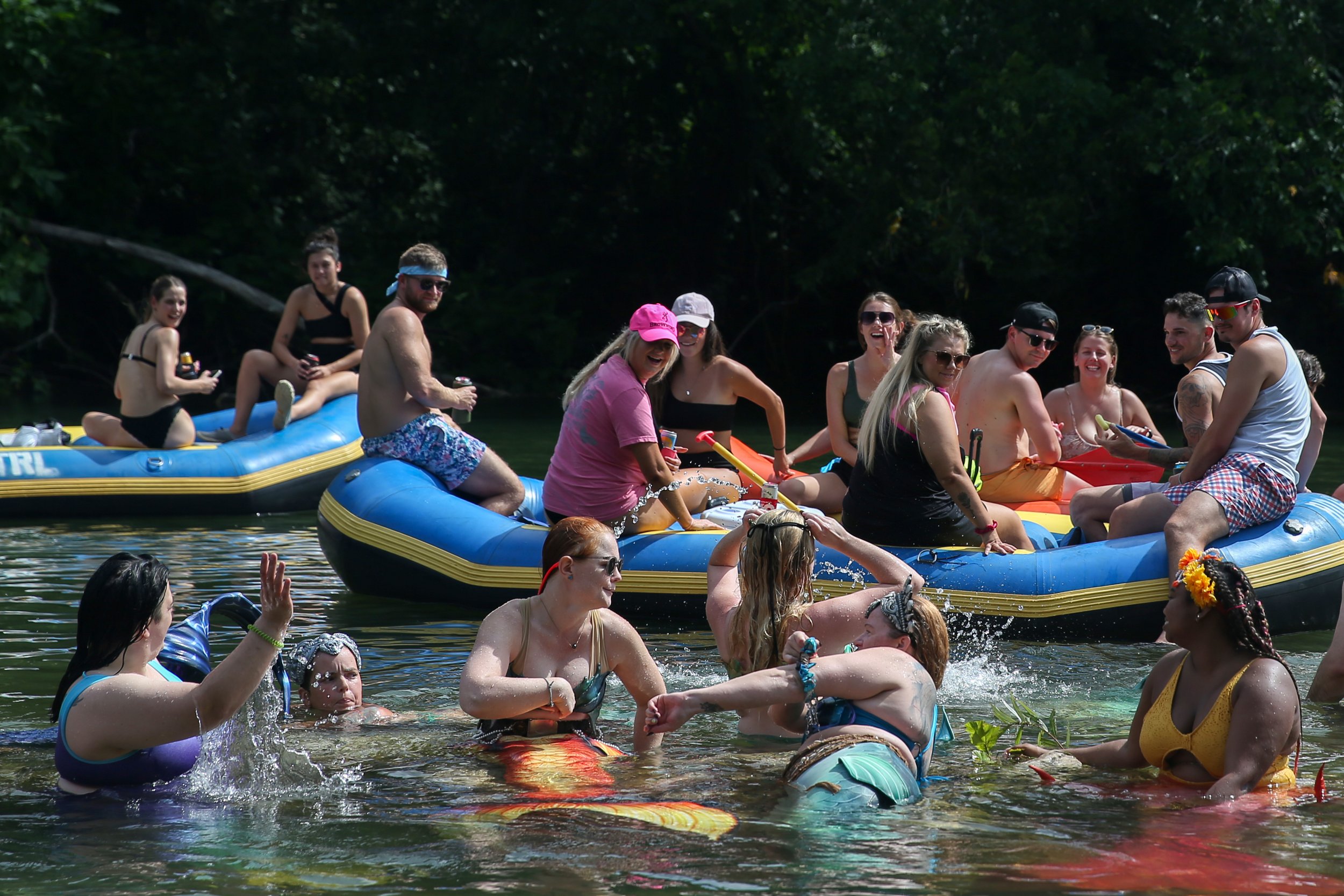  Mermaids wave as groups floating by notice them on Saturday, Aug. 5, 2023, on the Black River in Lesterville, Mo. The event, entitled the First Midwest Merfolk River Takeover, brought mermaids from both Illinois and Missouri to the river for three d