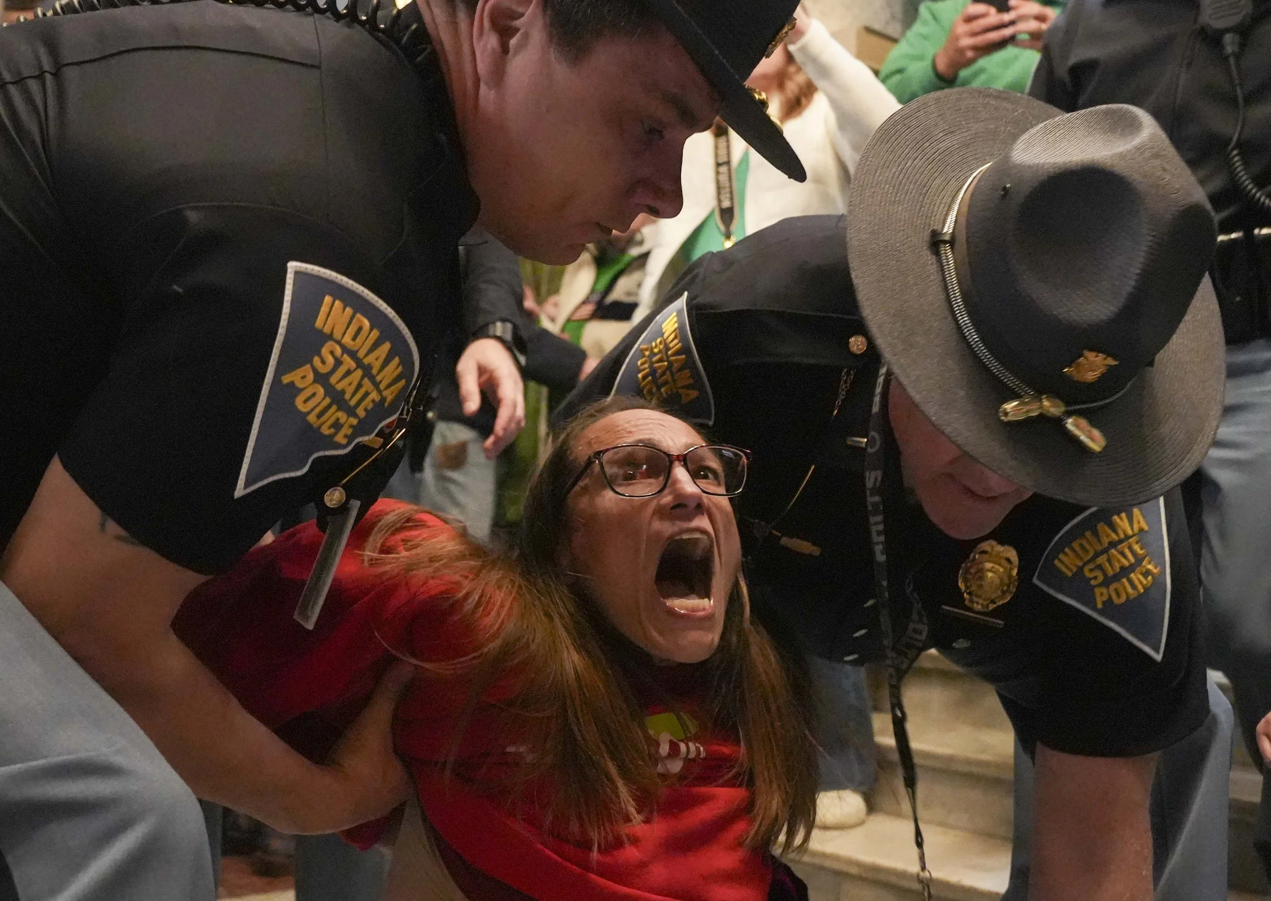  Christina Smith, leader of the Indianapolis Education Justice Coalition, is arrested while protesting for public education reform during a property tax reform rally on Monday, March 17, 2025, at the Indiana Statehouse.  