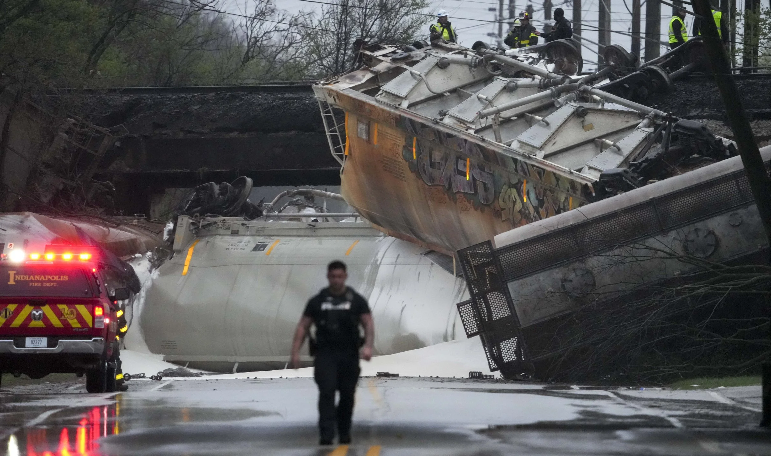  Members of law enforcement work the scene after a train derailed Sunday, April 6, 2025, near Southeastern Avenue and South Sherman Drive in Indianapolis. 