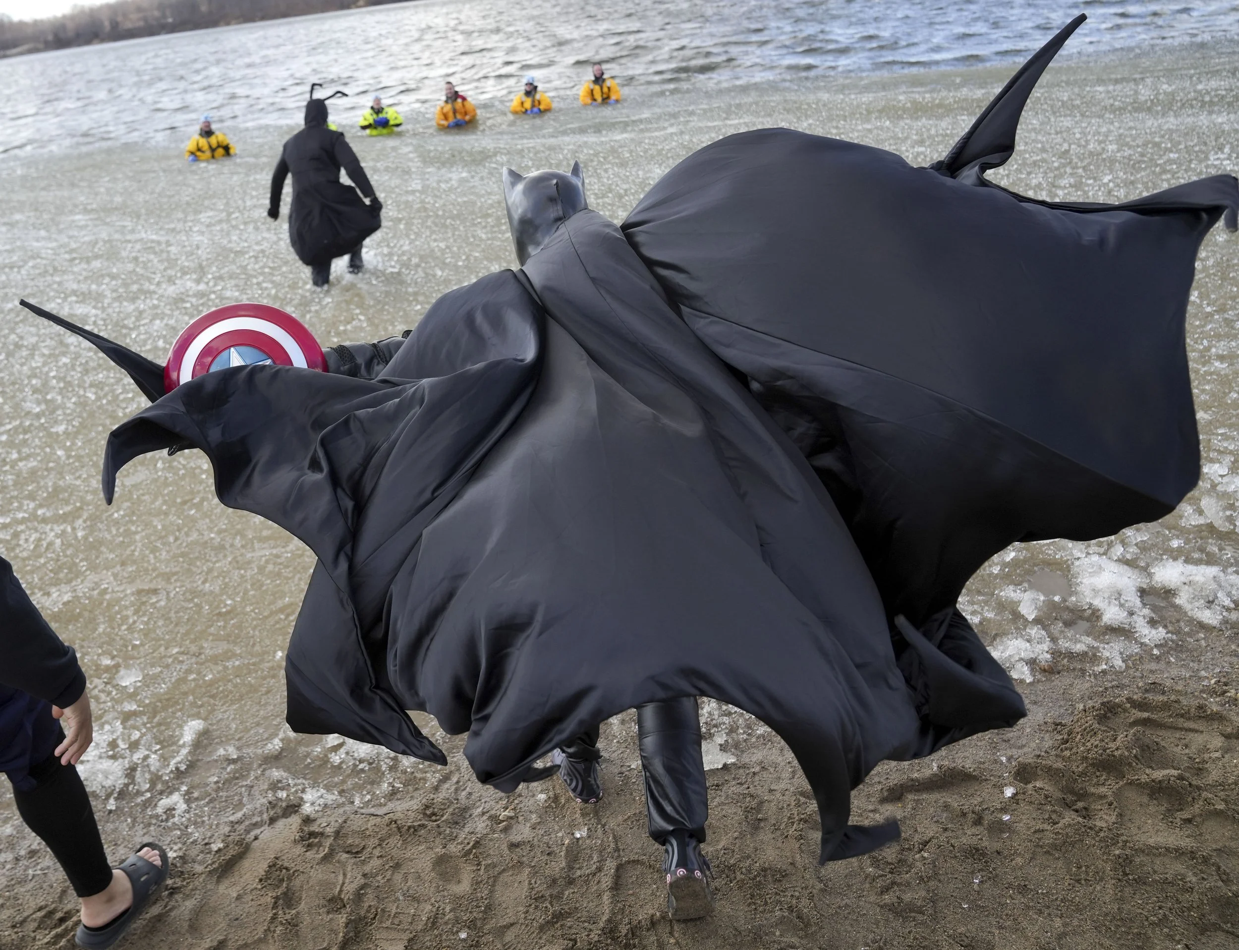  Nick LeRose, an officer with the Parkview Health Police, enters the water Thursday, Feb. 27, 2025, during a Polar Plunge fundraiser at Eagle Creek Park in Indianapolis. Students at the Indiana Law Enforcement Academy took part in the Polar Plunge in