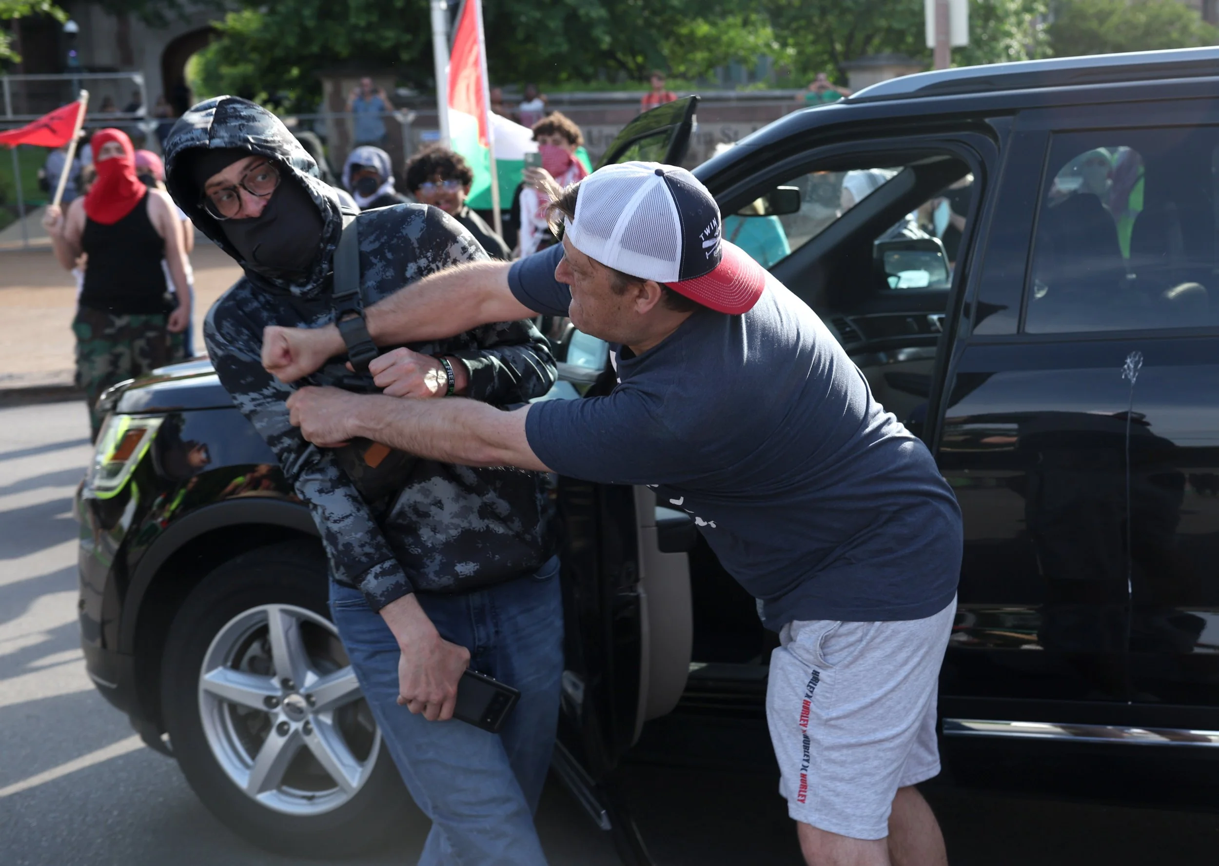  A motorist gets into a fight with a pro-Palestinian activist during a protest in the intersection of Forest Park Parkway and Skinker Boulevard on Friday, May 3, 2024, in St. Louis. The protest was held nearly one week after roughly 100 people were a