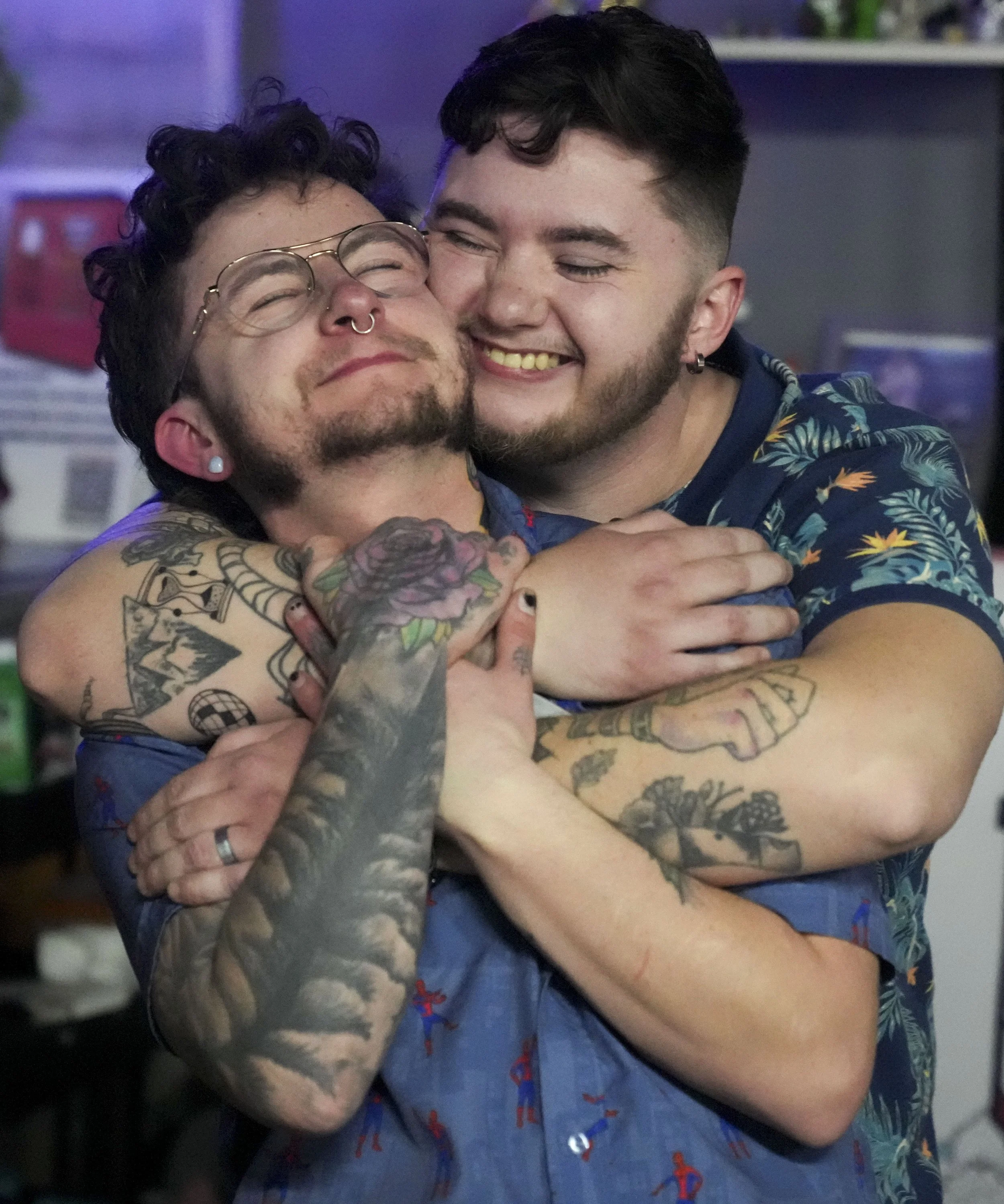  Myles Parker (front) gets a hug from friend Austin Parker (back) during a Boy’s Nite Valentine’s Day event Saturday, Feb. 22, 2025, in Indianapolis. Boy’s Nite, organized in part by Parker, is a monthly meet up event for transmasculine individuals t