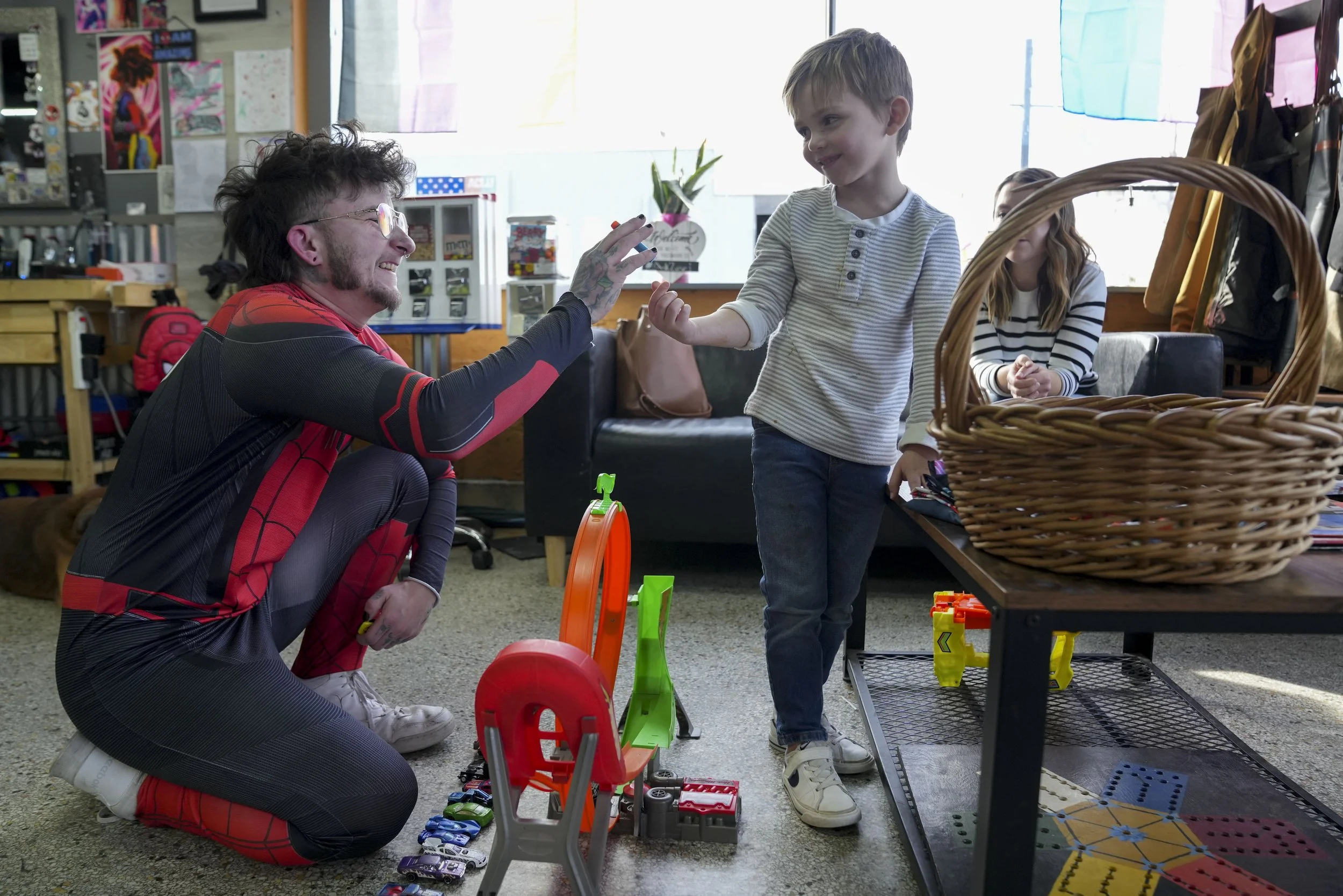  Barber Myles Parker (left) plays with Wilder Wilson, 5, before cutting his hair Tuesday, Feb. 4, 2025, at Bareknuckles Barbershop in Irvington.  