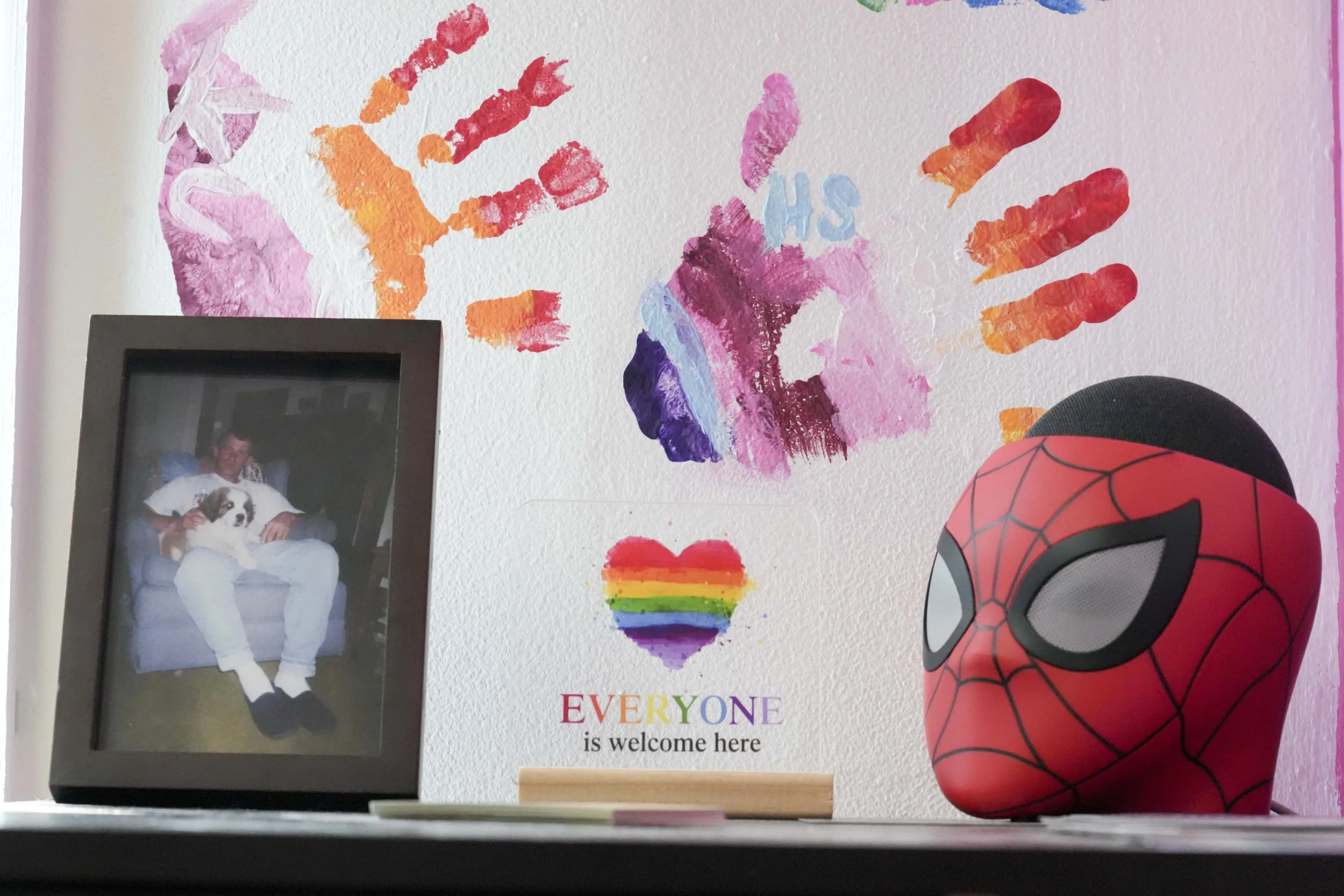  Decorations, including a photo of Myles Parker’s late father David Strode, sit on a shelf at Parker’s barbershop, named Webhead's Barbershop, on Friday, July 11, 2025, in Fountain Square.  