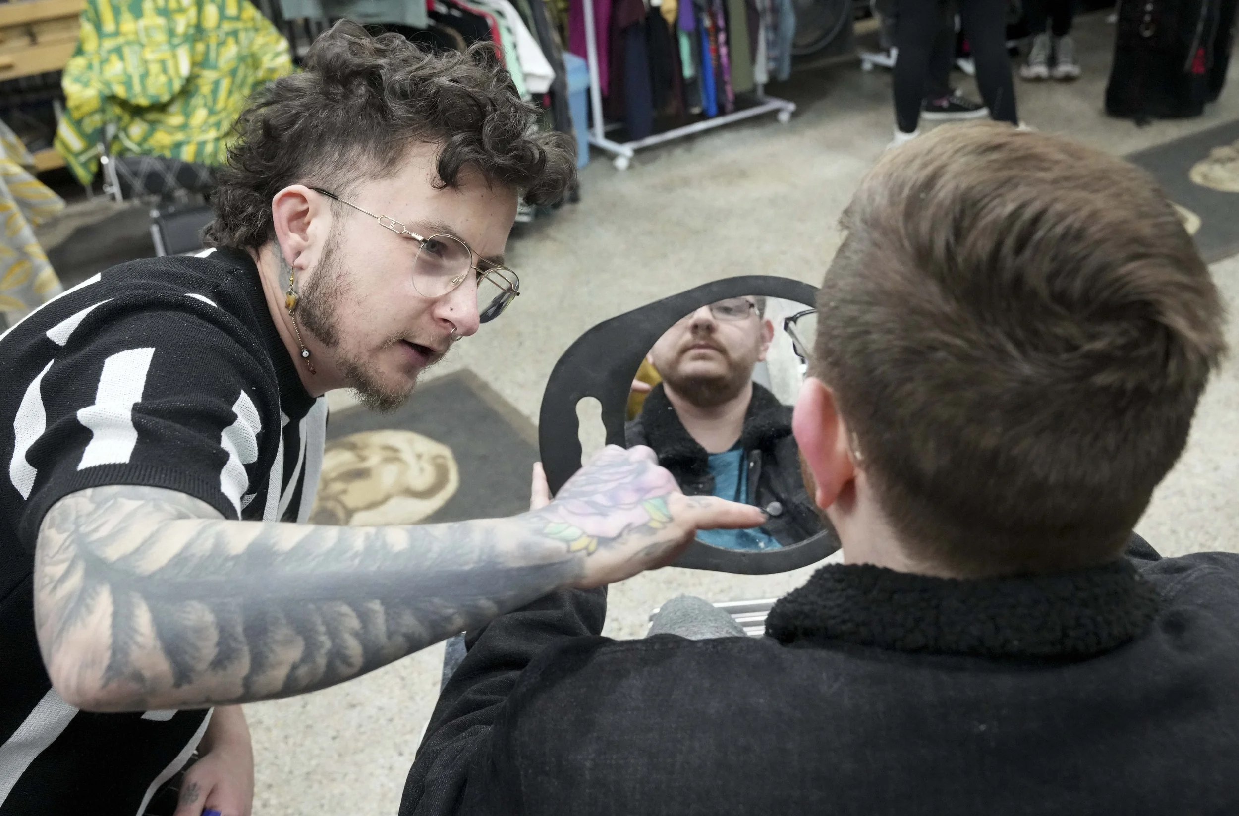  Barber Myles Parker (left) demonstrates how to care for beard hair to Kai during a get ready with me event Monday, Feb. 10, 2025, in Indianapolis. The event, organized by Parker, featured gender affirming beard care and makeup for transgender indivi